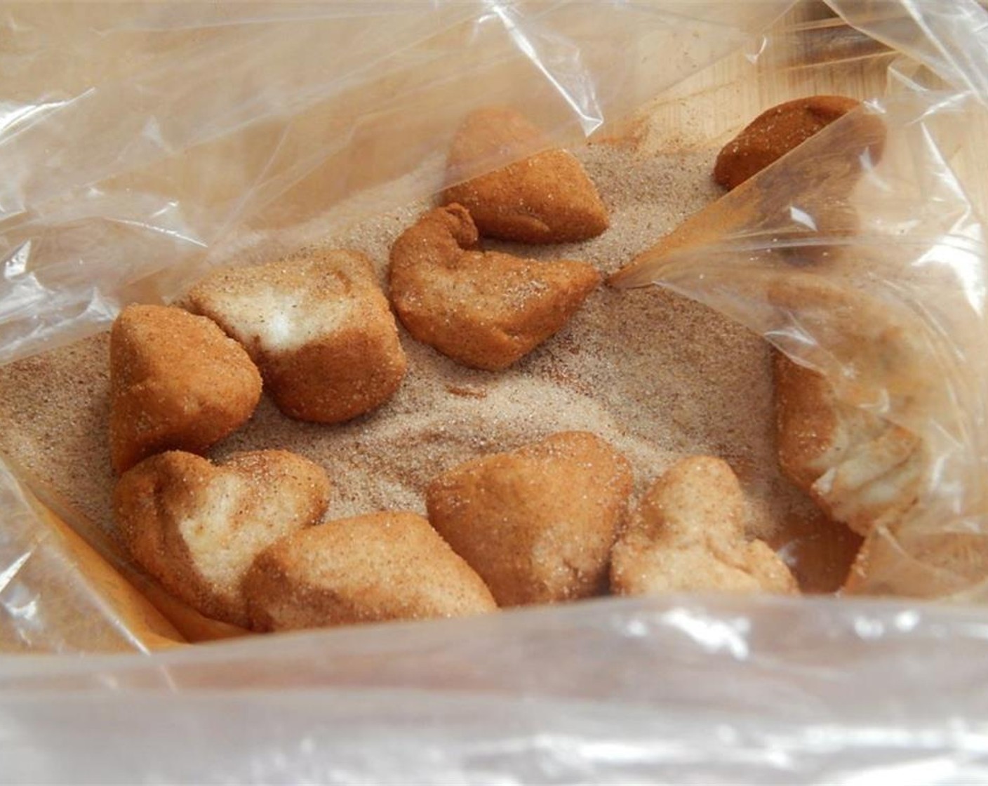 step 3 Mix Granulated Sugar (2 Tbsp) and Simply Organic Cinnamon, Ground (1 tsp) together in a bag. Add your biscuit pieces 8-10 at a time and coat well.