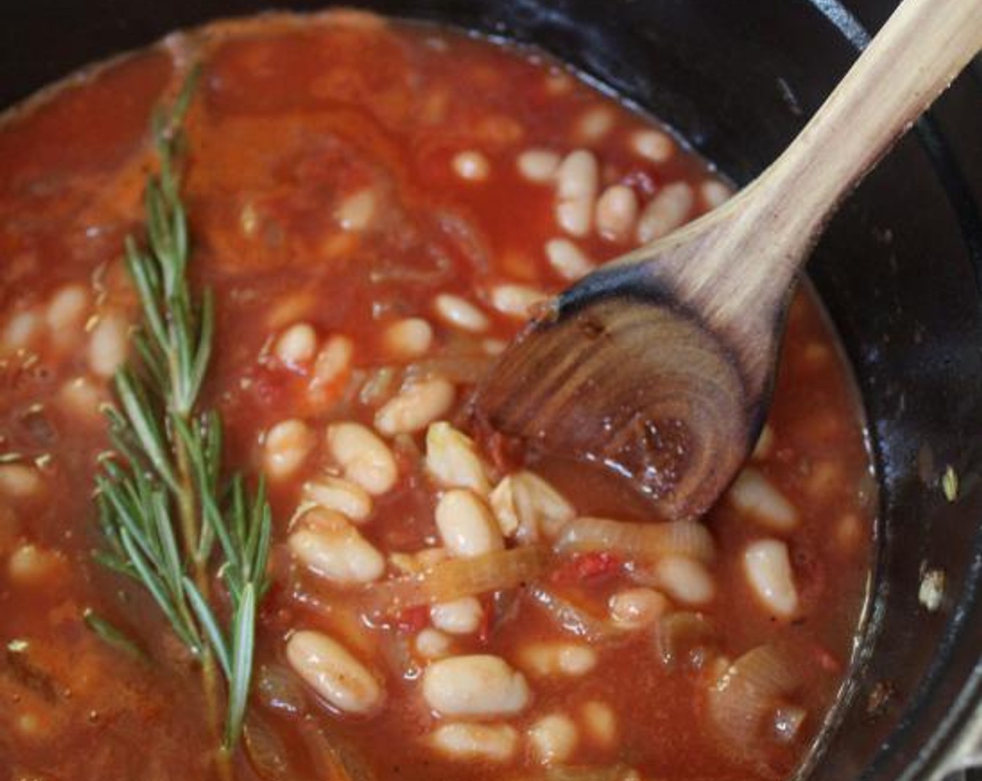step 5 Add the Dry White Wine (1/2 cup) and cook until reduced by half. Add the Canned Cannellini White Kidney Beans (4 1/4 cups), Tuscan Kale (3 cups), Canned Crushed Tomatoes (1 cup), Low-Sodium Chicken Stock (1 1/2 cups), Fresh Rosemary (1 sprig), and Kosher Salt (1 tsp) and bring to a boil.  Lower the heat and cook at a full simmer for 35 minutes, stirring occasionally.