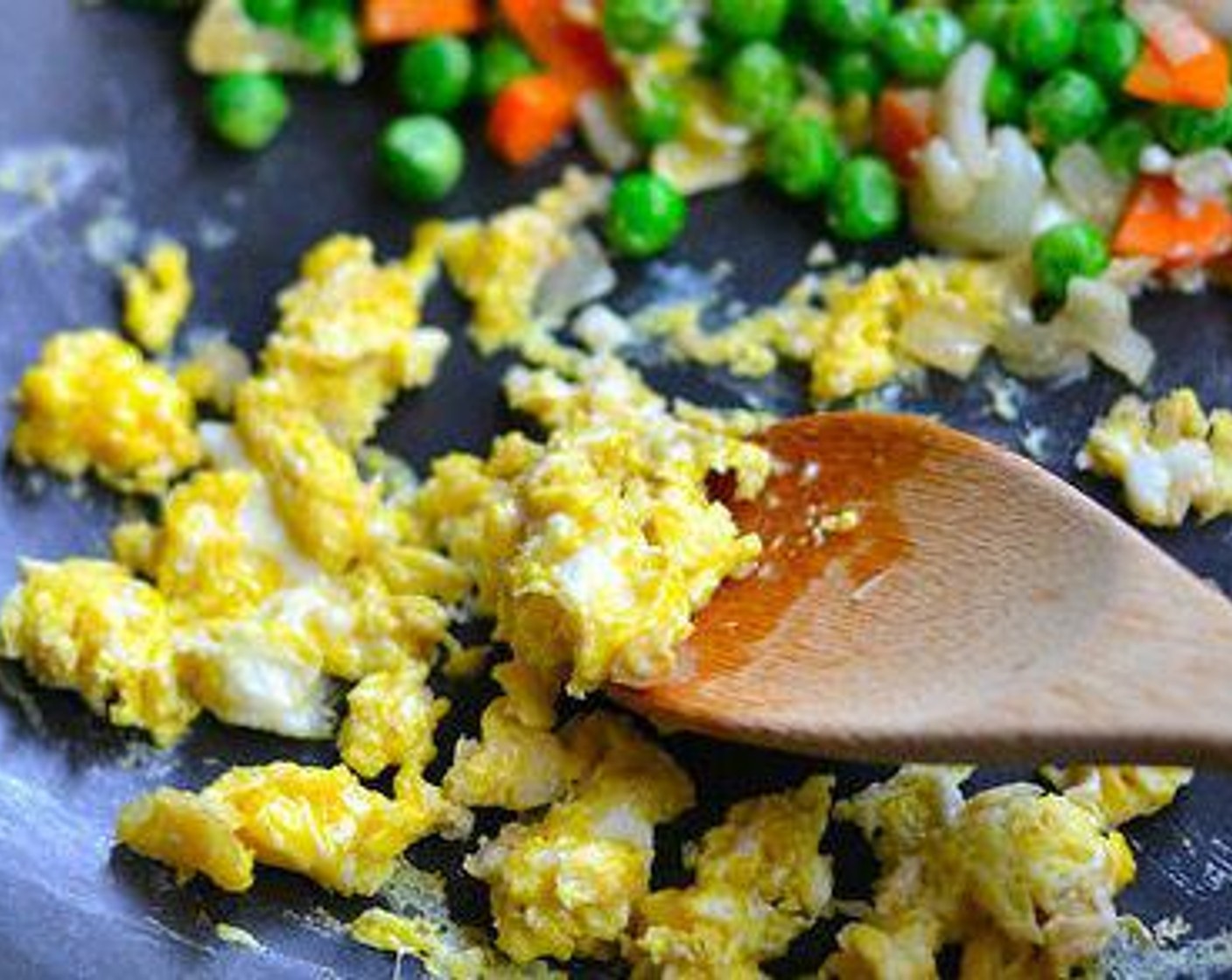 step 2 Push vegetables to the side of the pan and add the Egg (1). Scramble it quickly and then mix everything together.