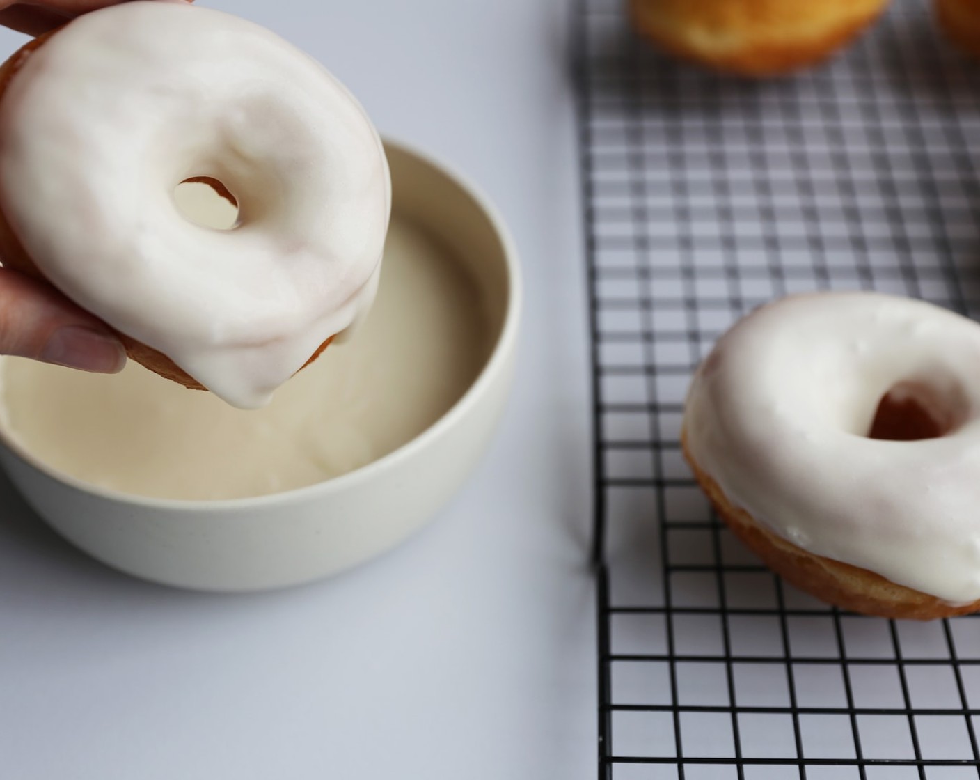 step 20 Twisting the doughnut out of the bowl, allow excess glaze to drip off the doughnut and place back on to the wire rack to set for about 30 minutes.