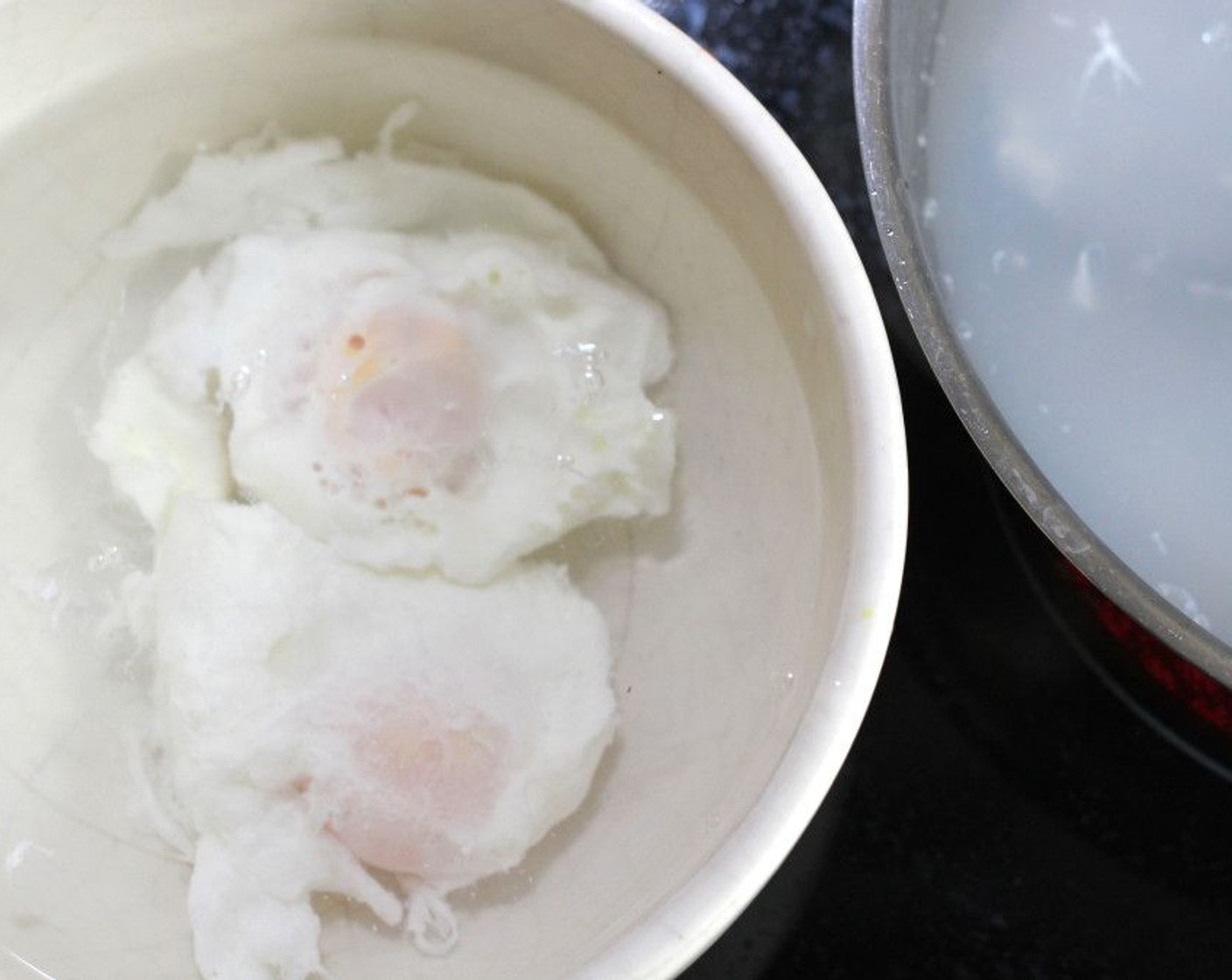 step 2 Poach Eggs (2) to your preferred doneness, shock in ice water, place on absorbent paper.