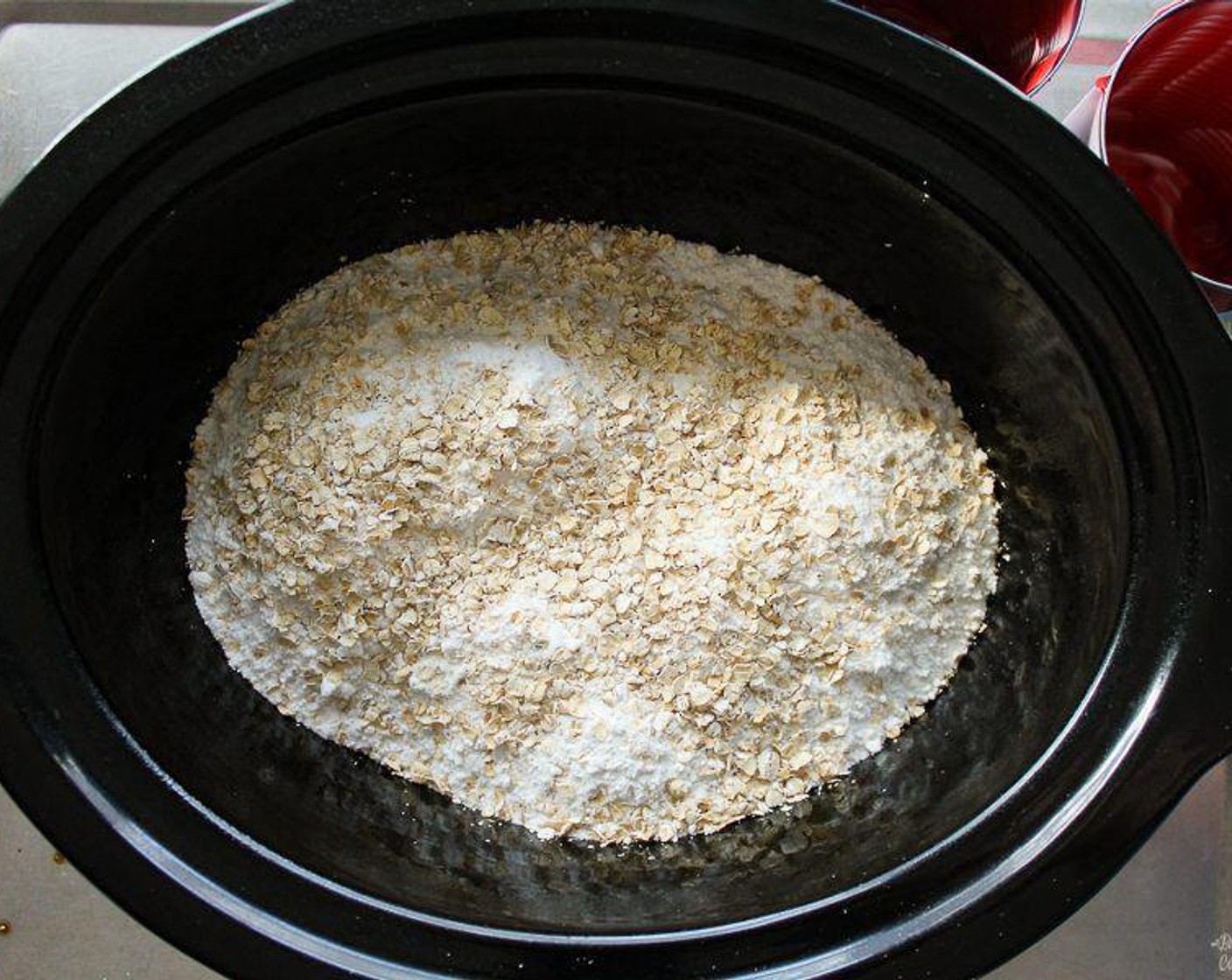 step 2 Pour the Cherry Pie Filling (4 1/3 cups) into the bottom of the slow cooker. Layer the Yellow Cake Mix (1 box) over the top. Sprinkle with the Oats (1/2 cup).