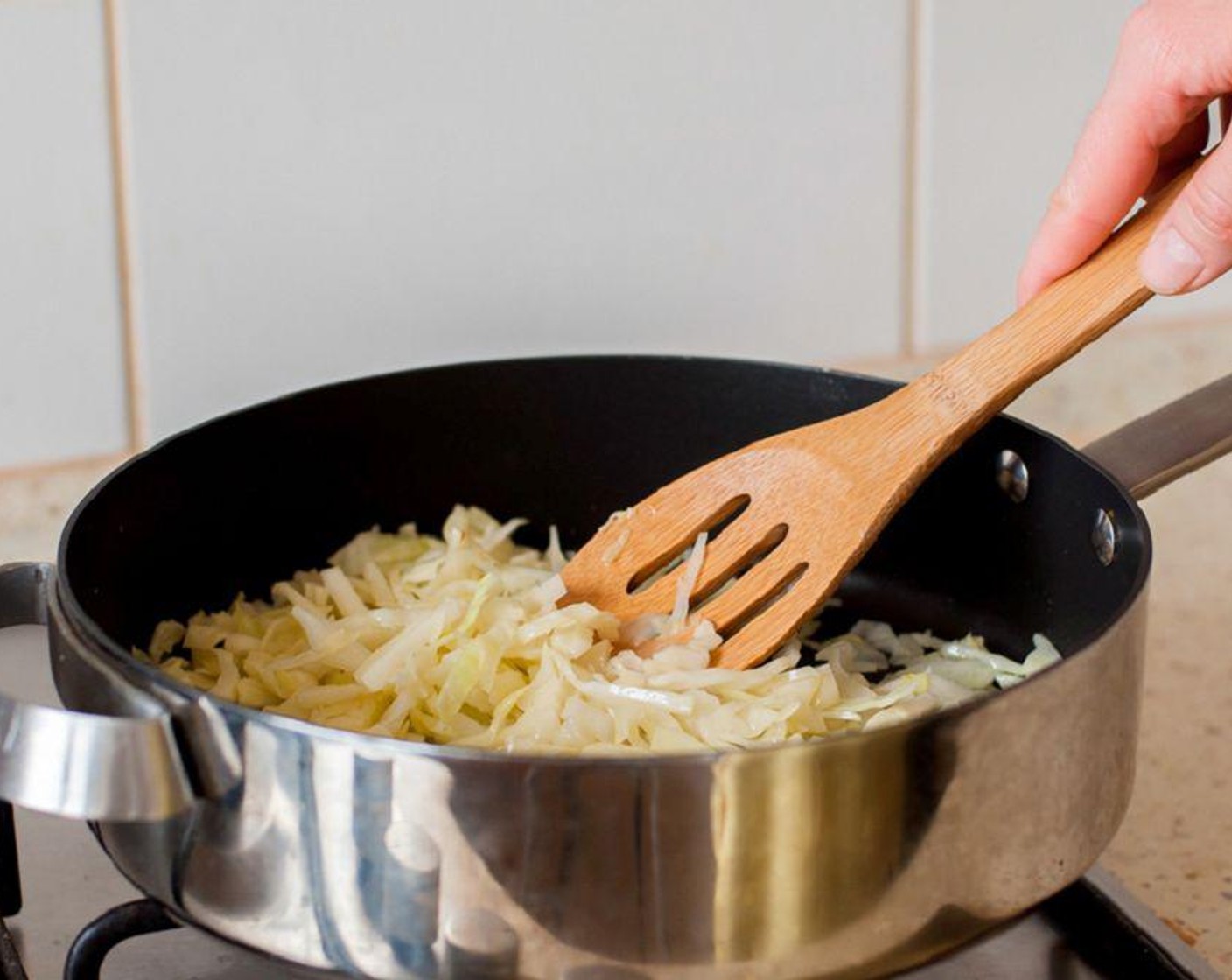 step 3 Prepare the filling by stirring the shredded Savoy Cabbage (4 cups) for 10-15 minutes in a saucepan, or until it becomes soft. Drain and squeeze the excess liquid. Set it aside to cool.