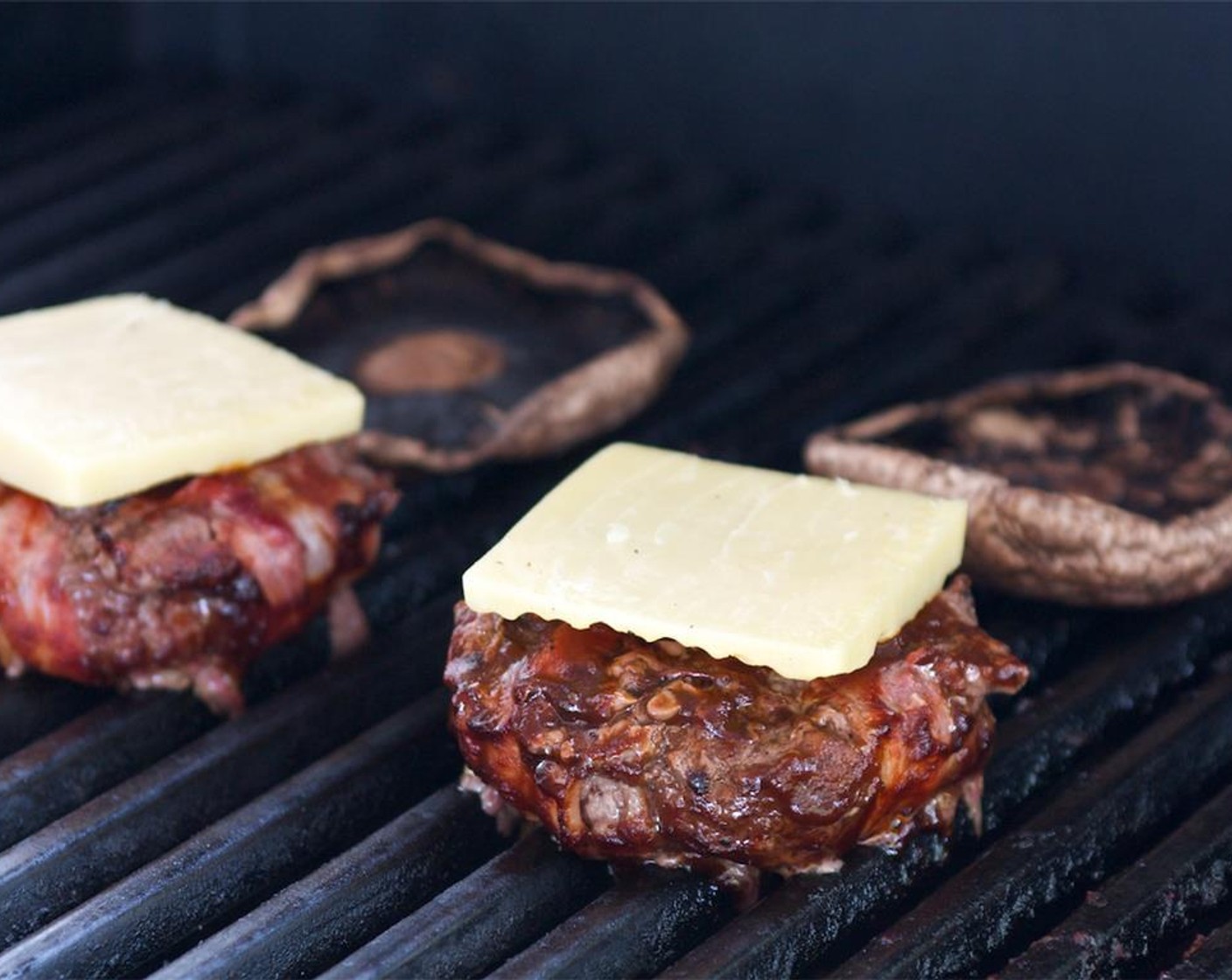 step 7 Lower the heat to medium high and cook for 6-8 minutes depending on the thickness of your patties. Turn the burgers, brush with the remaining barbecue sauce, and top with the Cheddar Cheese (4 slices).