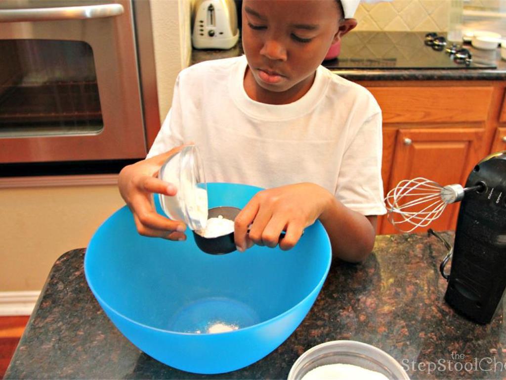 Step 5 of Simple Vanilla Soufflé Recipe: In a separate bowl, mix together Granulated Sugar (1/3 cup), All-Purpose Flour (1/3 cup) and the remaining Milk (1/3 cup) until it forms a smooth batter.