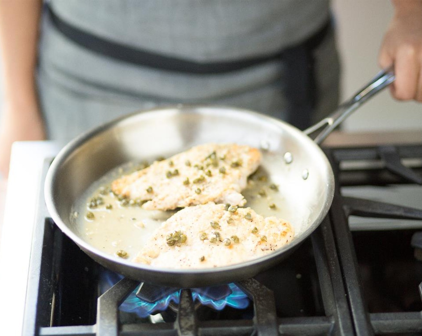 step 12 Add the roasted lemon juice, White Cooking Wine (1/4 cup), lemon zest, Capers (2 Tbsp) and chicken broth. Reduce liquid until chicken is coated and sauce is slightly thickened.