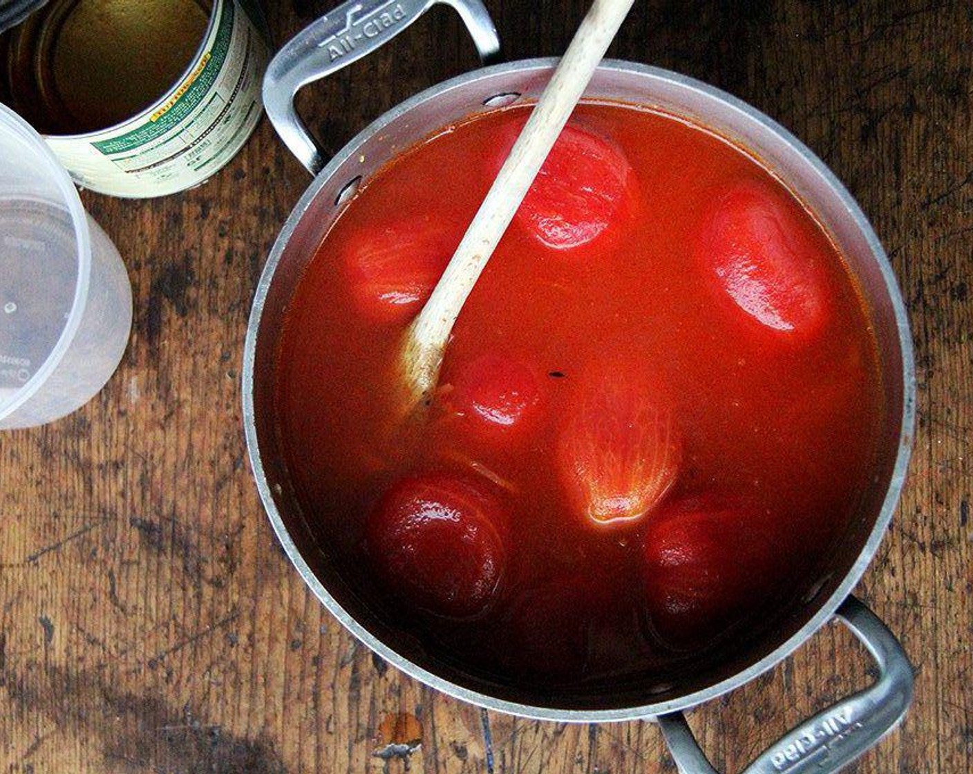 step 3 Add Canned Whole Peeled Tomatoes (6 2/3 cups) with juices and Water (4 cups) to pot. Increase heat to high; bring to a simmer. As the plum tomatoes rise to the surface while the soup simmers, use scissors to cut them up.