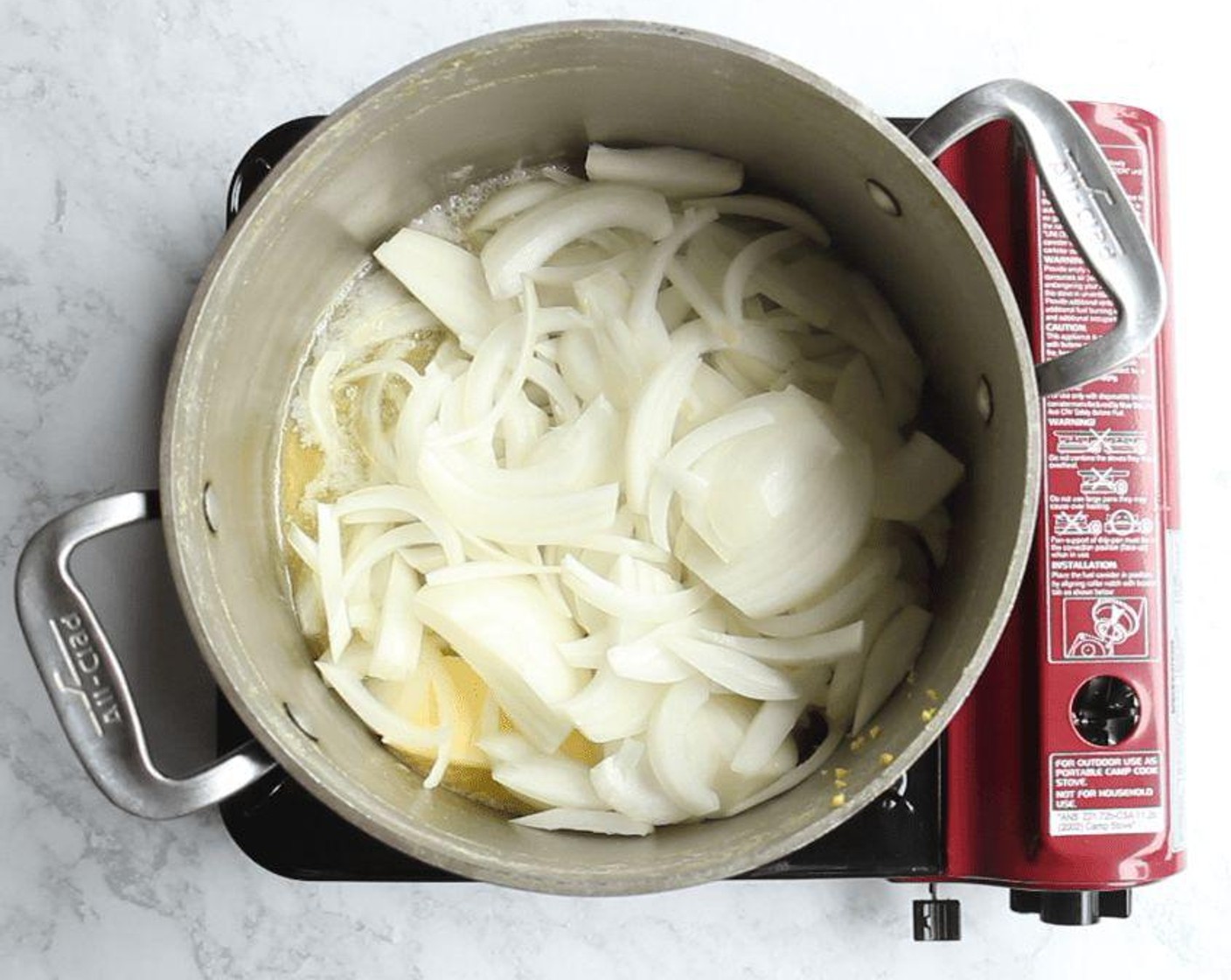 step 3 Return the empty pot to the stove and heat over medium heat. Add the Unsalted Butter (1/2 cup). Once it has melted, add the Yellow Onions (2) and reduce heat to medium-low. Cook, stirring occasionally, until the onions are translucent, or blond, about 20 minutes.