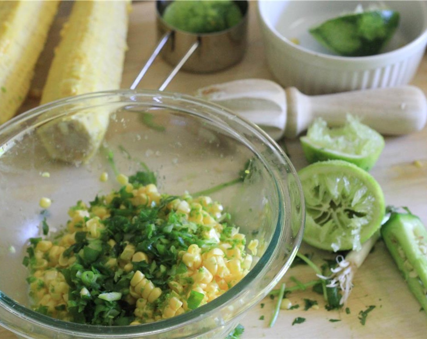 step 4 Add the zest and juice of half the Lime (1), olive oil (1), green onion, and jalapeno to the corn and stir to coat. Add half the cilantro and salt and give it another stir. Allow flavors to blend for 10 minutes. Taste for salt.