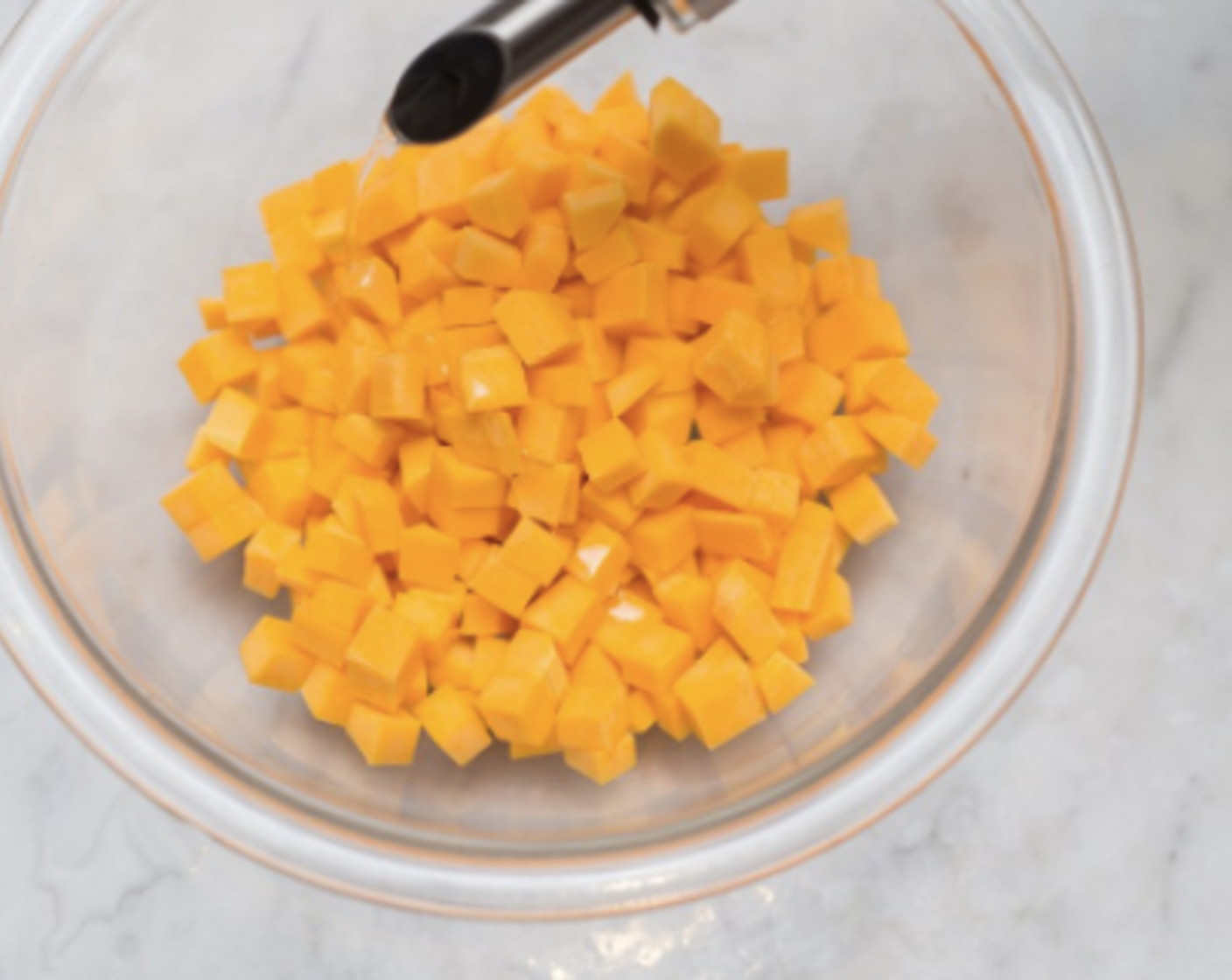 step 3 In a bowl, toss butternut squash with Olive Oil (1 cup). Spread on a baking sheet or baking pan, and roast 10-15 minutes, until tender when pierced by a fork.