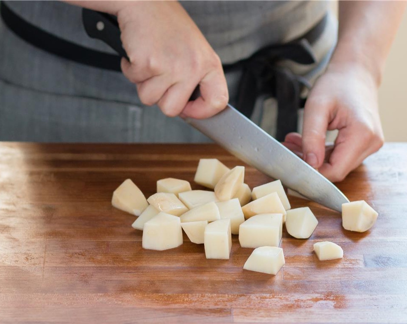 step 1 Peel and cut the Russet Potatoes (2) in half lengthwise. Next, cut potato halves crosswise into 4 pieces to yield 16 equal chunks and place them in a medium saucepot. Cover with cold water and bring to a boil over high heat.