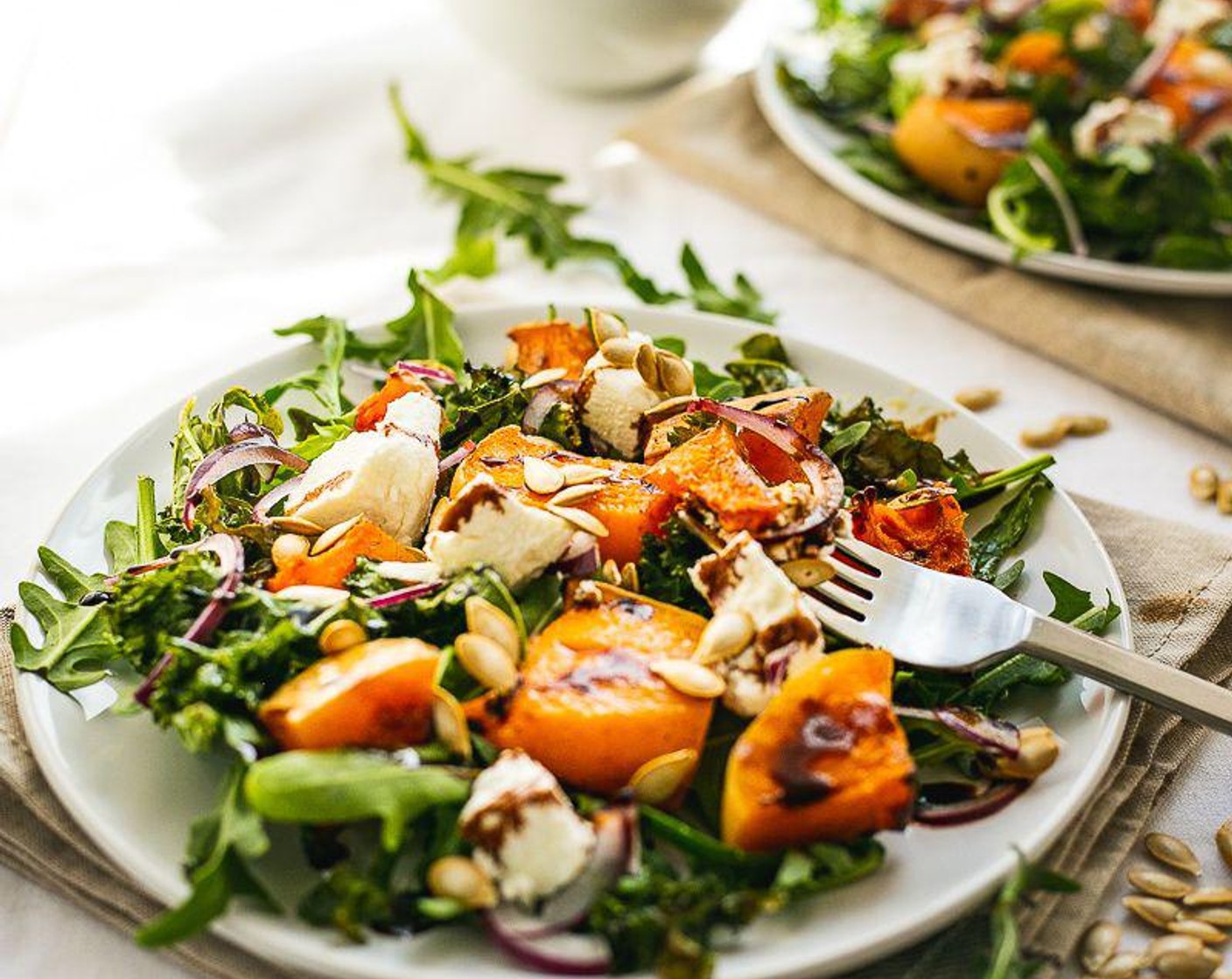 step 6 On a plate, add Arugula (to taste) as a base, then add the kale, squash, squash seeds, Red Onion (1/2), and Goat Cheese (1 cup). Drizzle some Balsamic Glaze (to taste) on top. Serve and enjoy!