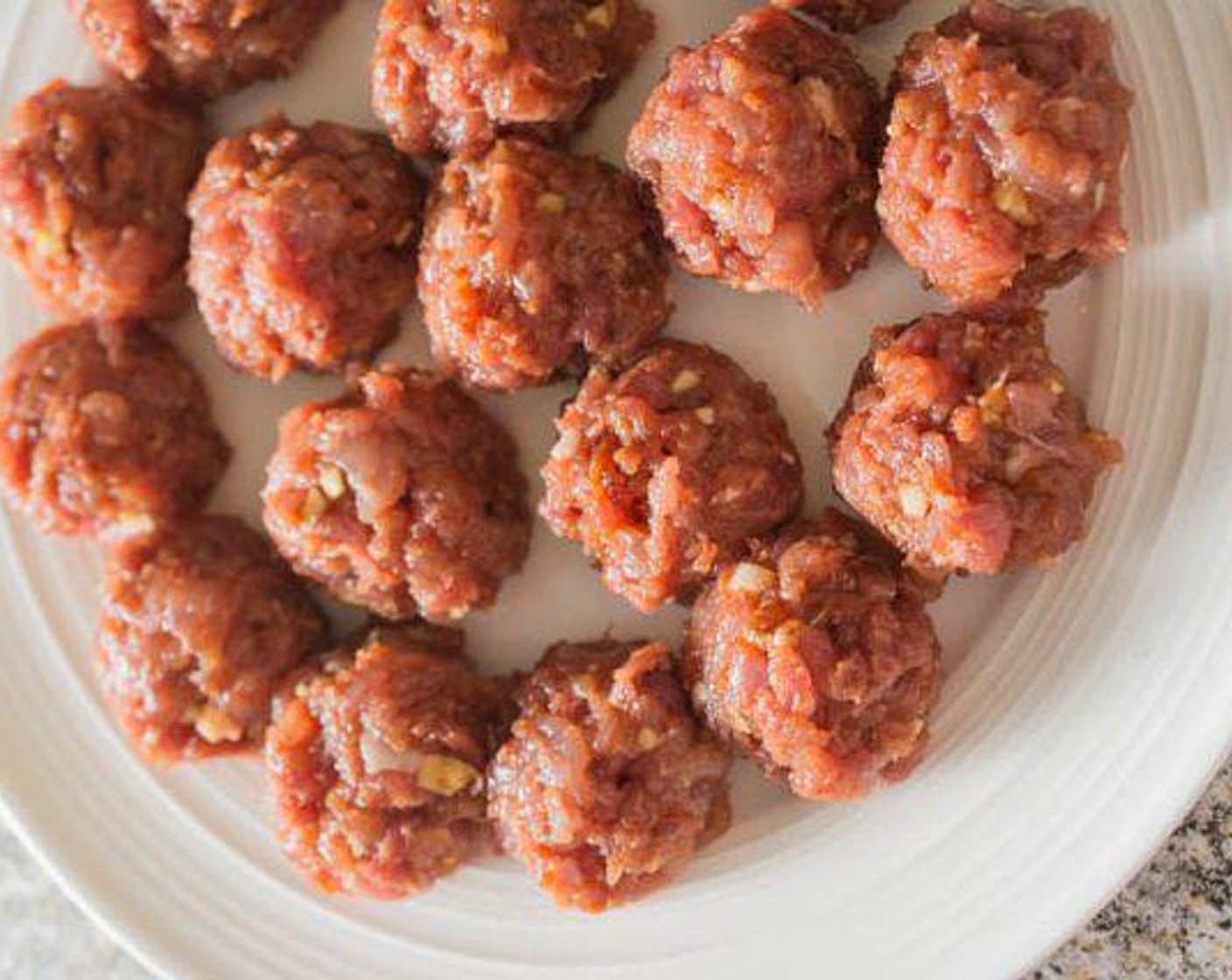 step 2 Roll the ground pork mixture into 1 1/2 inch meatballs (approximately 1 heaping tablespoon each).