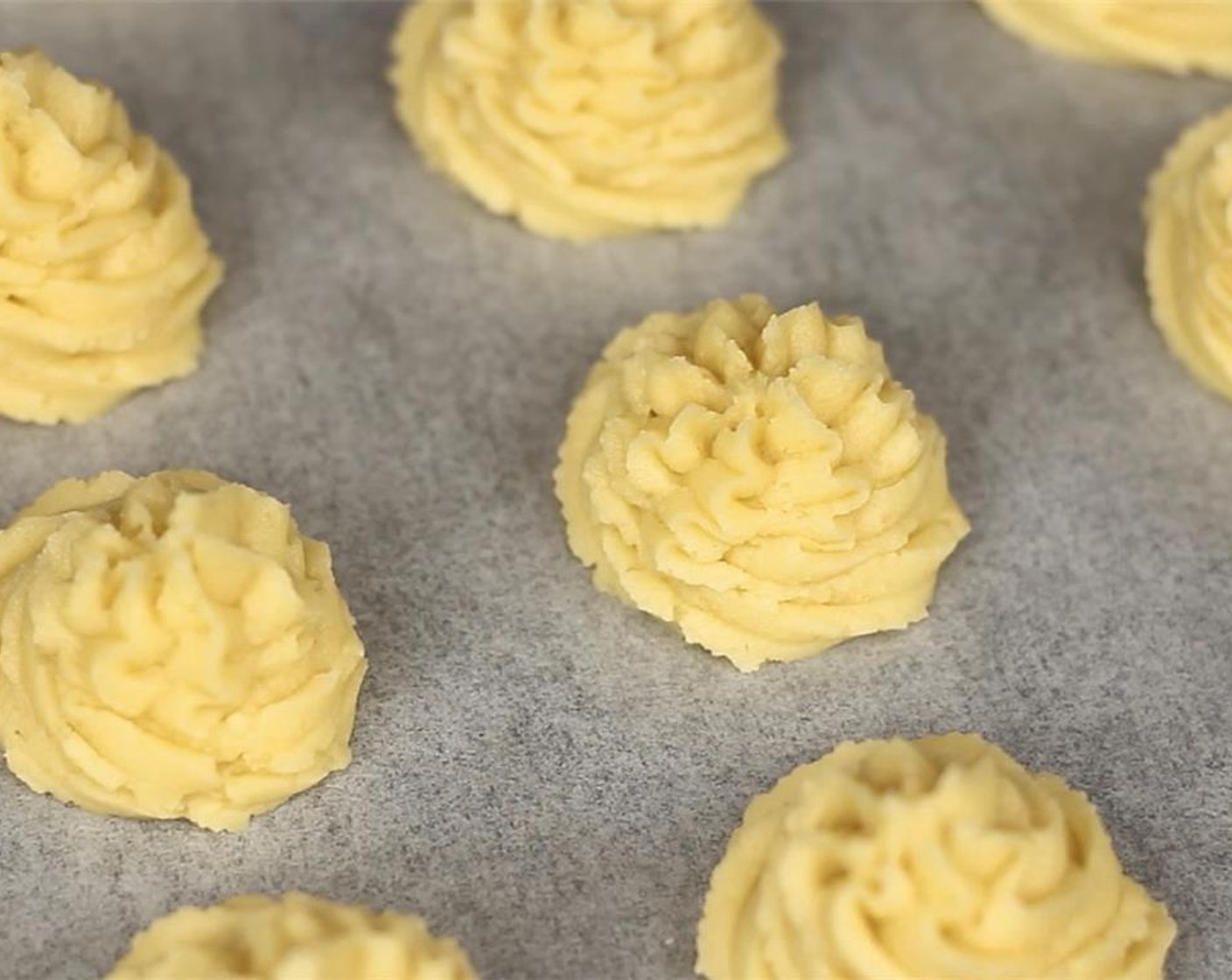 step 4 Transfer into piping bag with a star tip. Pipe evenly onto a baking tray lined with parchment paper.