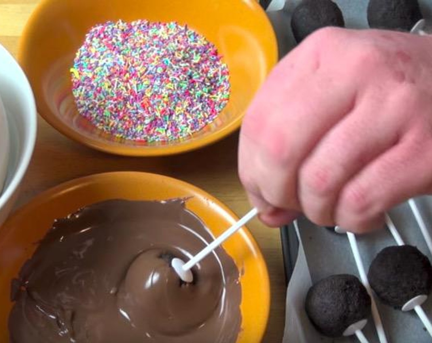 step 3 Dip the pops in the melted chocolate, shake off the excess and roll it in the Sprinkles (to taste), if preferred. Use a Polystyrene ball to hold the pops. Continue on with the rest. Serve and enjoy!