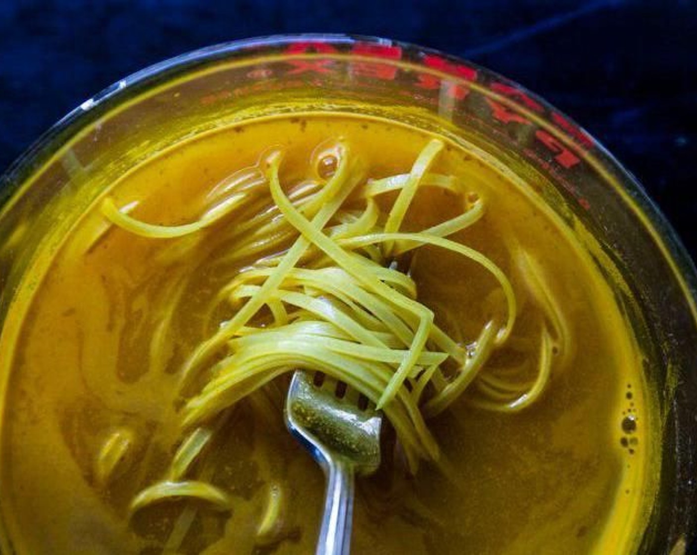 step 1 In a large mixing bowl, combine Ground Turmeric (2 Tbsp), Kosher Salt (1/4 tsp), Rice Noodles (1 pckg), and enough boiling water to cover the rice noodles. Let the noodles soak in the water for about 20 minutes. Once softened, drain the noodles and set aside.