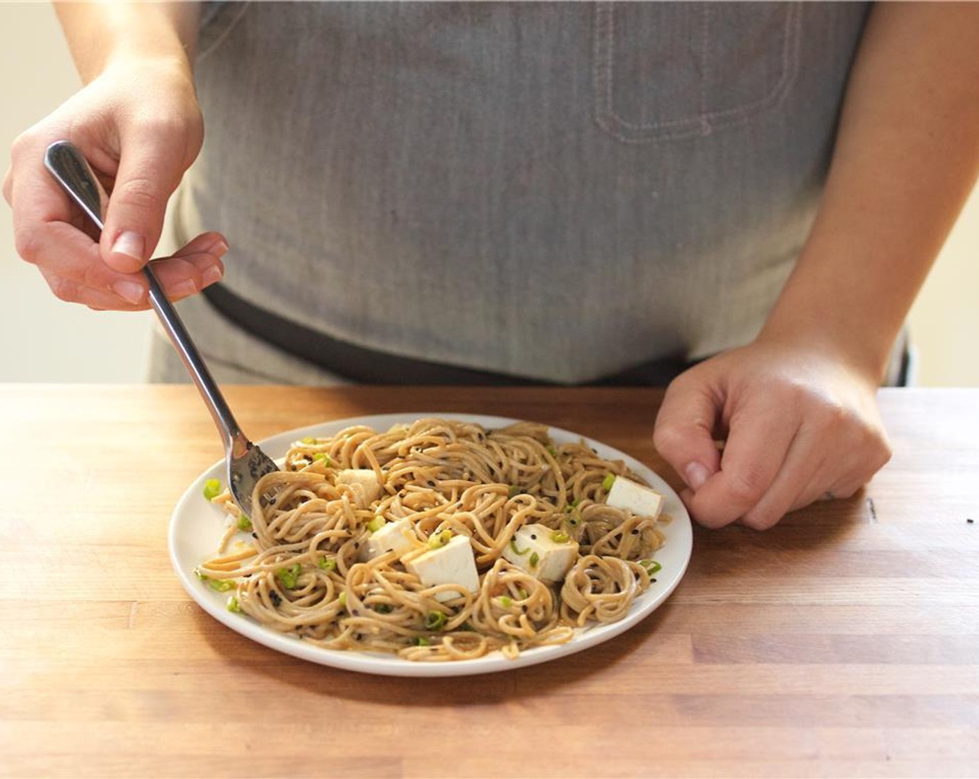 step 8 In the center of two plates, place the noodles. Top with the tofu and remaining vinaigrette on the side.