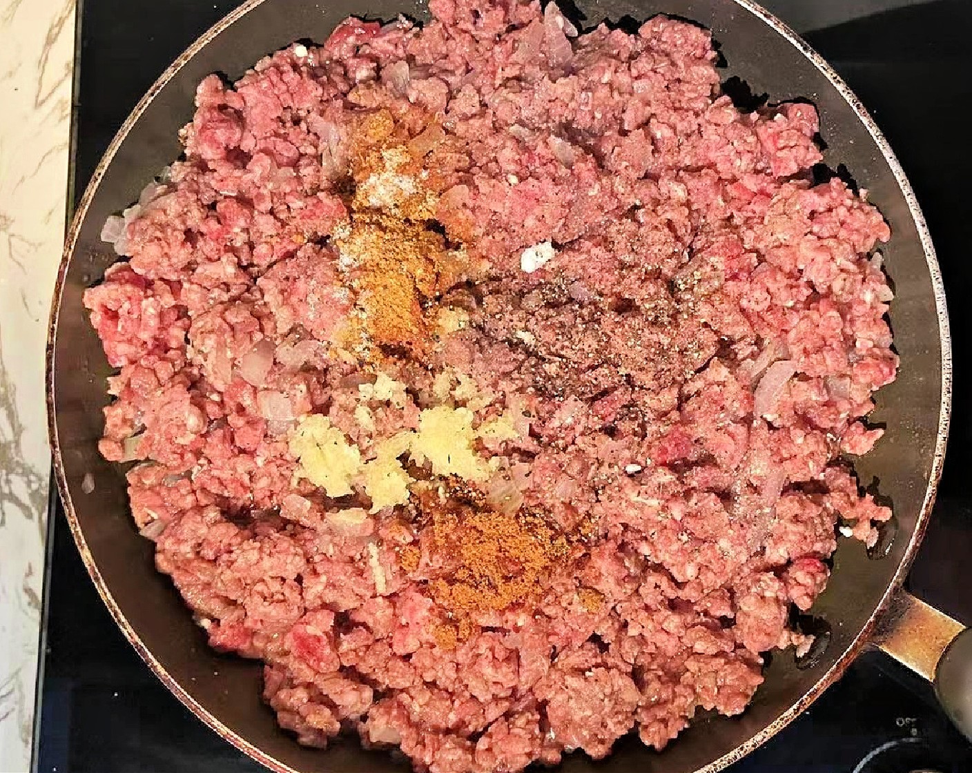 step 3 Add the Ground Beef (1.5 lb), Garlic (2 cloves), Paprika (1 tsp), Brown Sugar (1/2 tsp), Salt (to taste), and Ground Black Pepper (to taste). Stir and continue cooking until the beef is browned; about 15 minutes.