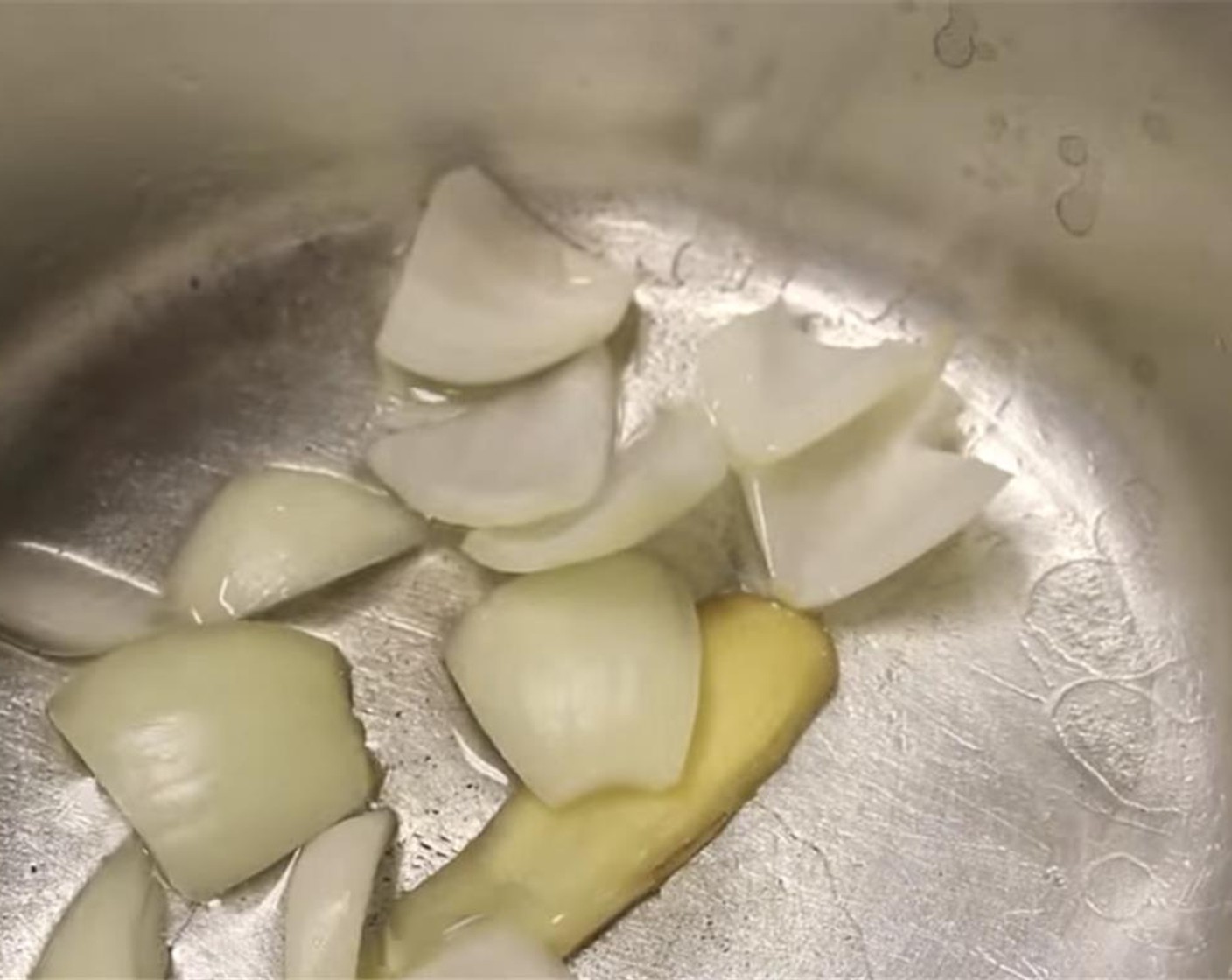 step 1 In a pot with Canola Oil (1/4 cup) at medium low heat, add chopped Onions (1 1/2 Tbsp) and Fresh Ginger (1 slice).