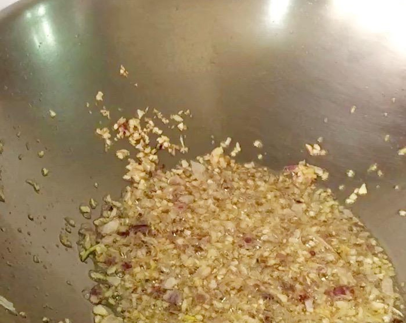step 4 Heat a wok with Vegetable Oil (1/4 cup) over medium-high heat. Add chopped garlic and shallots and saute until fragrant.