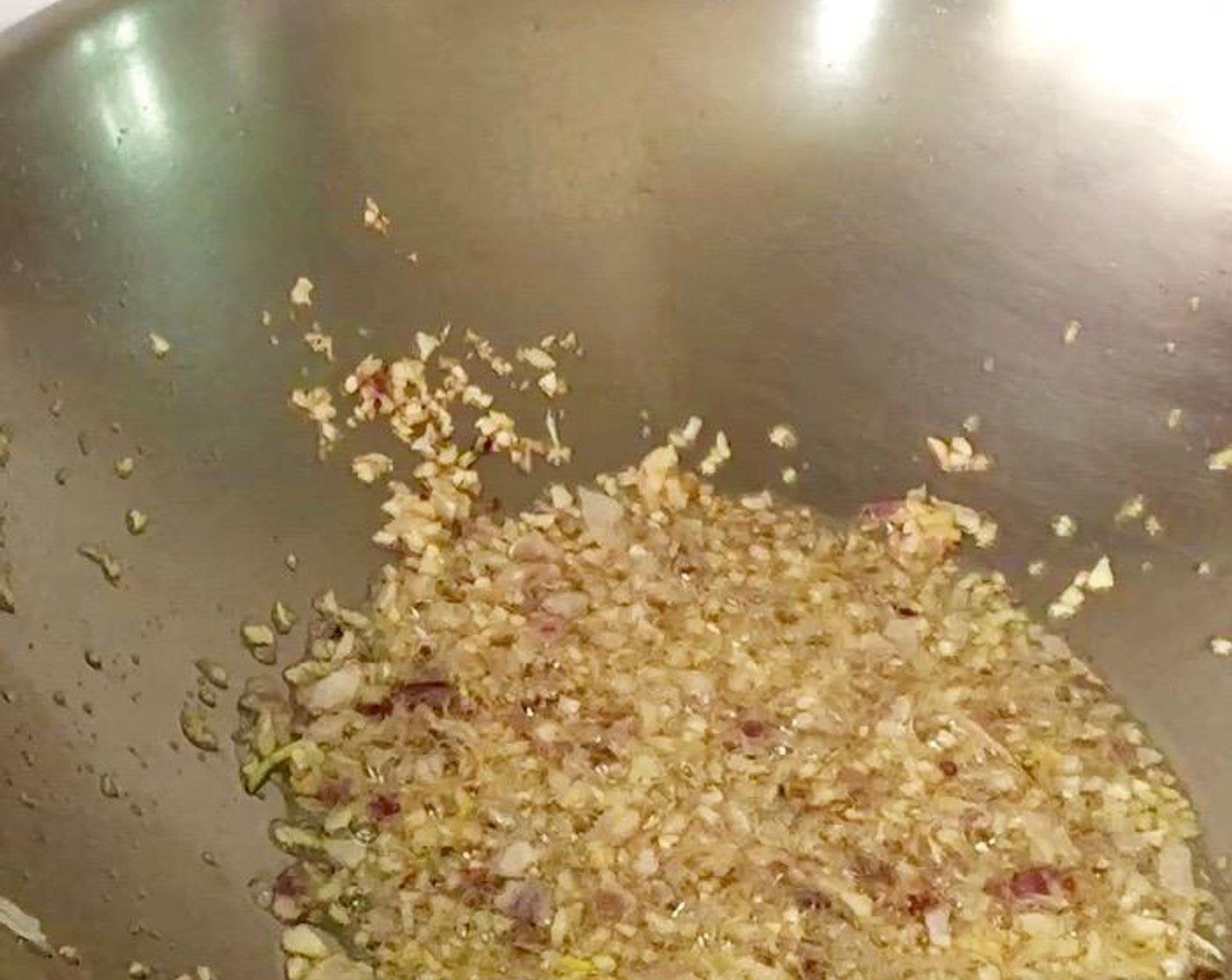step 4 Heat a wok with Vegetable Oil (4 Tbsp) over medium-high heat. Add chopped garlic and shallots and saute until fragrant.