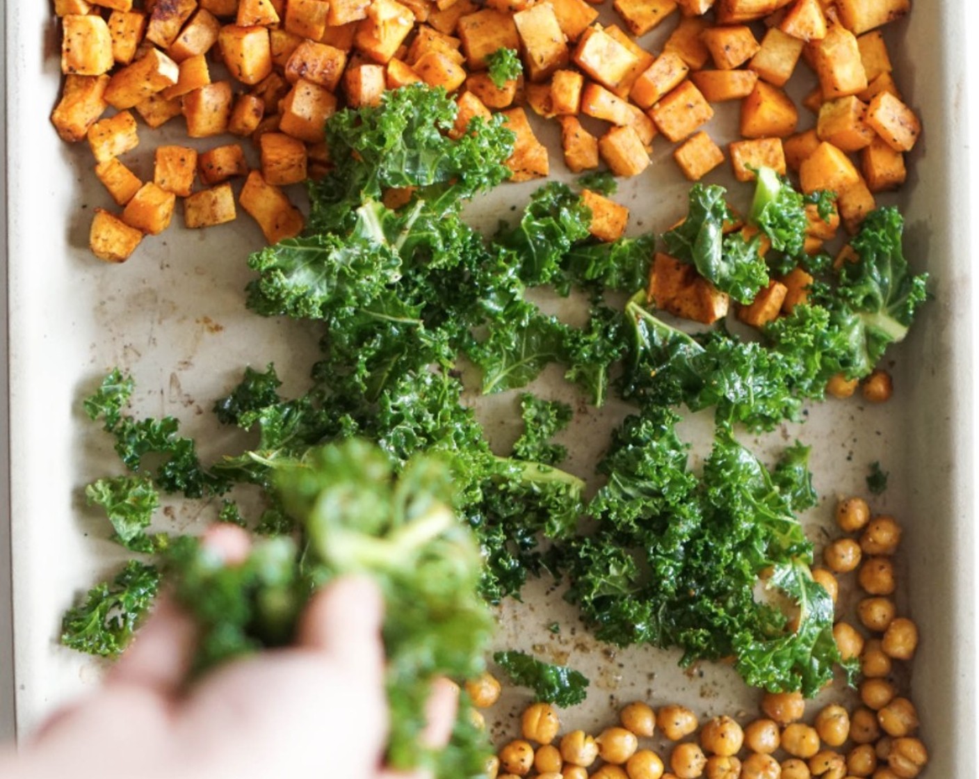 step 7 Remove the pan from the oven. Make enough room in the center of the pan and add the kale. Taste and adjust the peas if needed.