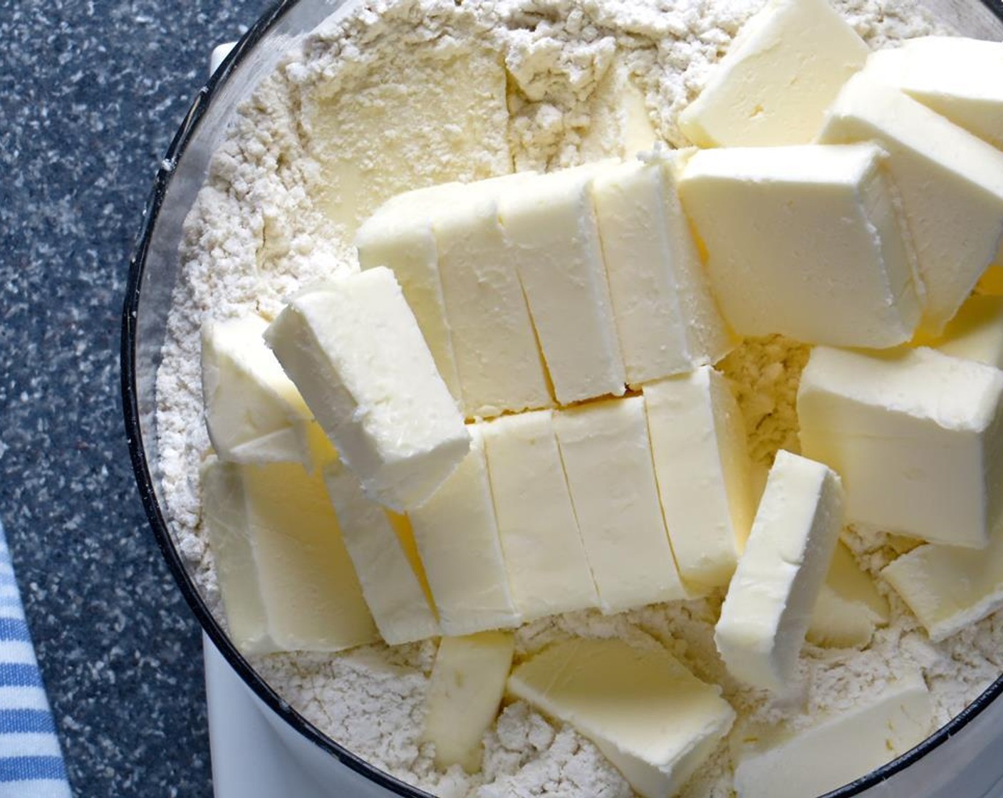 step 7 Add the dry ingredients to the bowl of a large (7 cups or greater) food processor fitted with the metal blade to cut the Unsalted Butter (1 1/2 cups) into the dry ingredients.