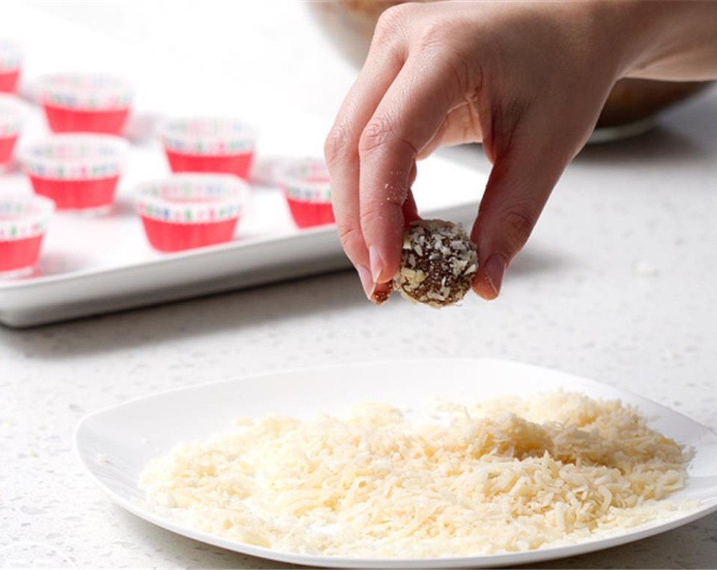 step 2 When the dough is fully mixed and slightly sticky, roll into balls. Roll the balls in the Unsweetened Shredded Coconut (1 cup).