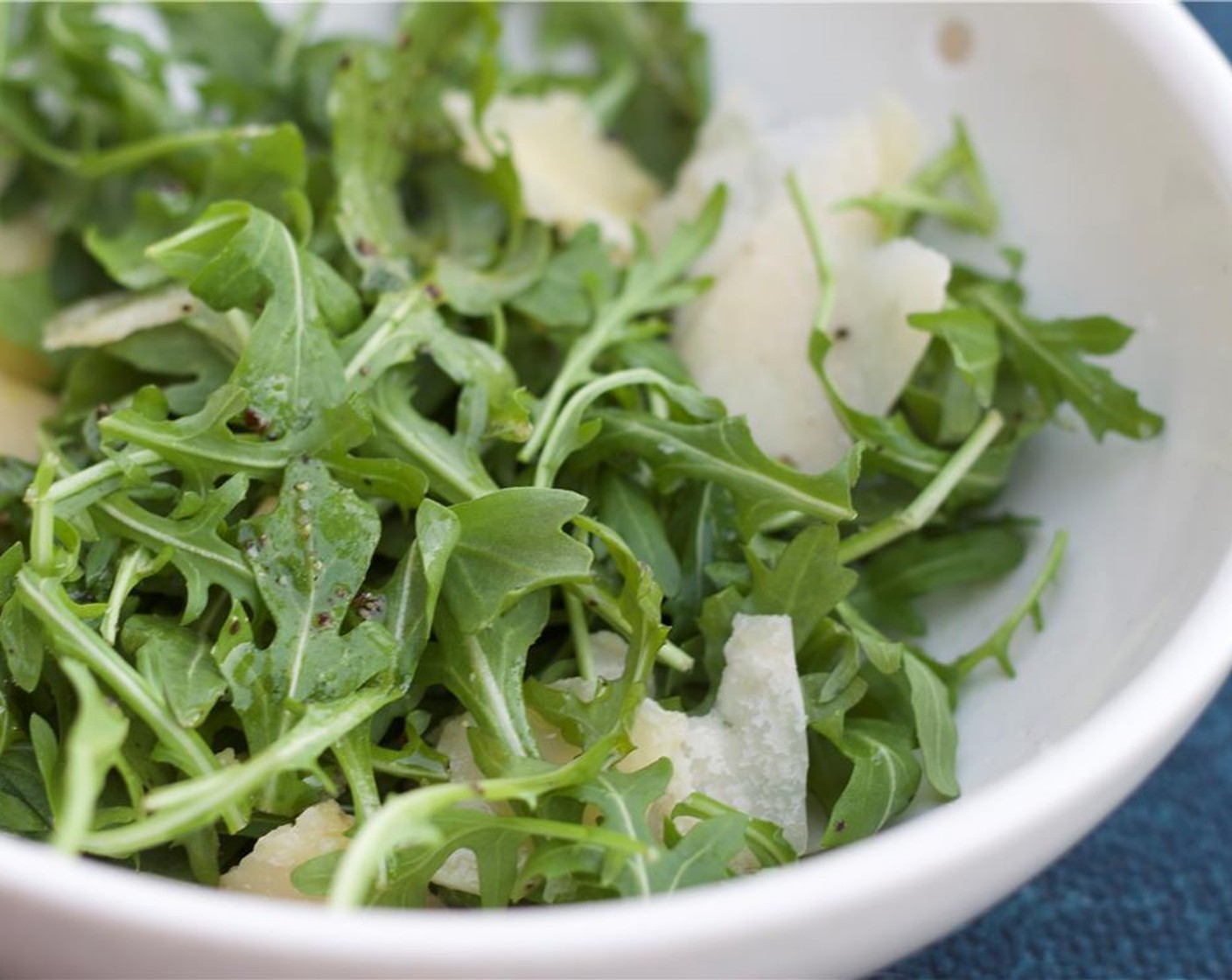 step 7 While the steak rests, toss the Parmesan Cheese (1/4 cup), Arugula (2 cups), with the juice of a Lemon (1), Olive Oil (1 Tbsp) and salt and pepper to taste. Toss to combine.