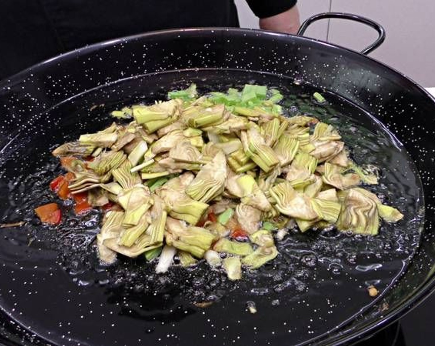 step 3 Place a pan over the heat with Olive Oil (as needed) covering the bottom of the pan. Add the vegetables in the following order: Green Garlic (6), Red Bell Pepper (1), Green Beans (6), and artichoke.