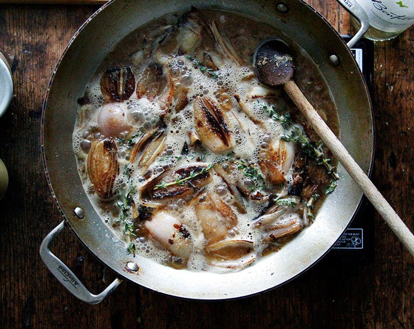 step 4 Add the White Wine (2 cups) and bring to a simmer, scraping the bottom of the pot with a wooden spoon to release any brown bits.