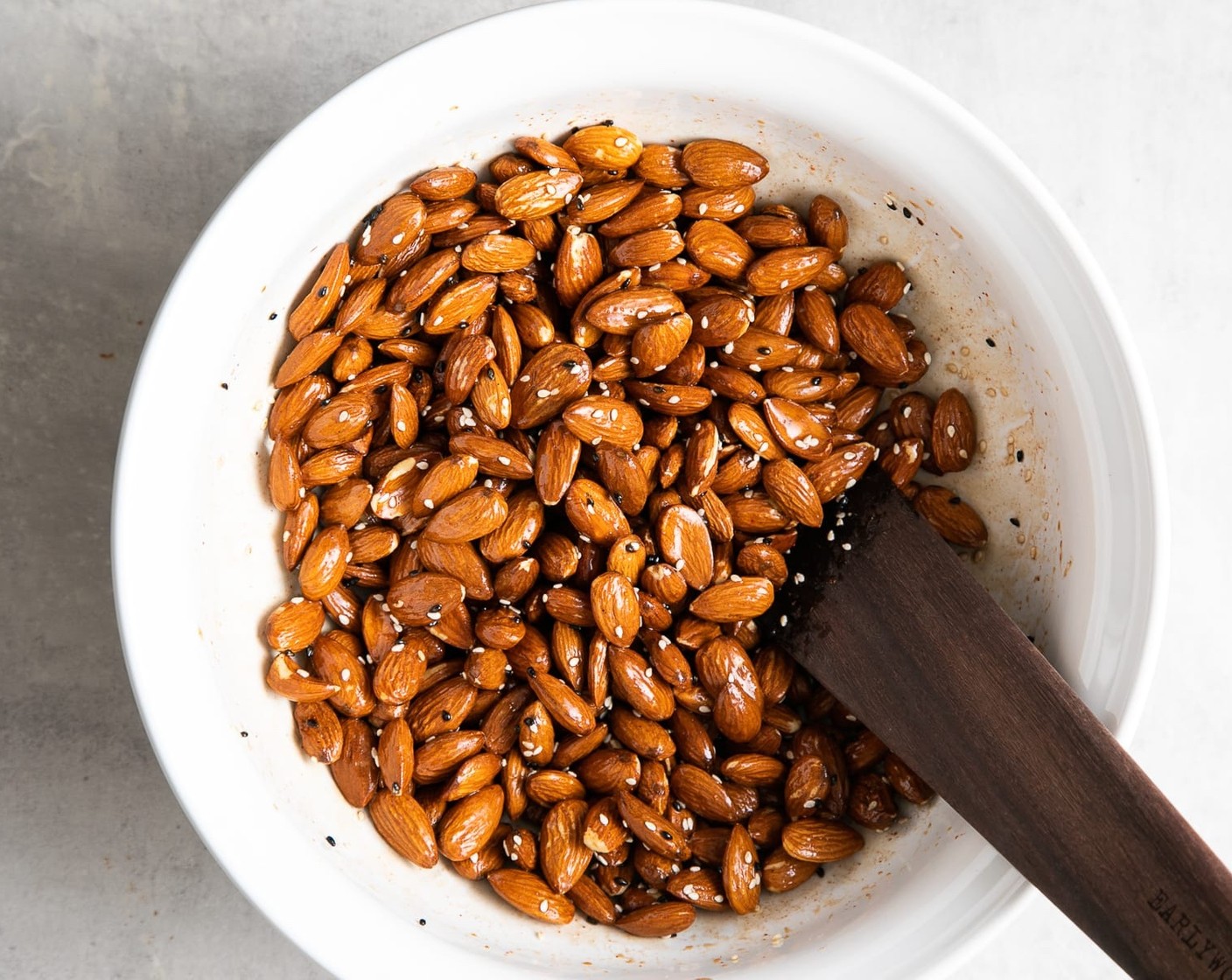 step 3 Put Raw Almonds (3 cups) in a large bowl, add the glaze and toss to coat. Add in White Sesame Seeds (1 Tbsp) and combine.