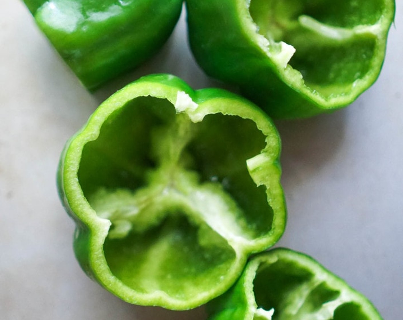 step 8 Prep the Bell Peppers (5). Cut the stem-end off the peppers, then use a spoon to scrape out any ribs or seeds. Rinse, dry, and rub the surface of the pepper with Olive Oil (as needed). Set peppers up-right in a baking dish.