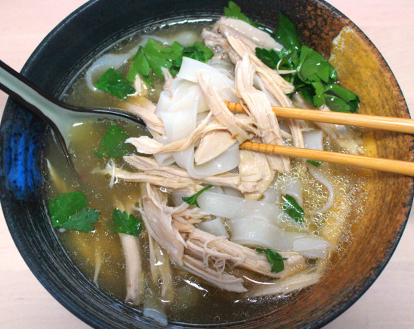 step 9 Add rice noodles to a bowl. Top with white meat, broth, and sprinkle generously with Fresh Cilantro (to taste).
