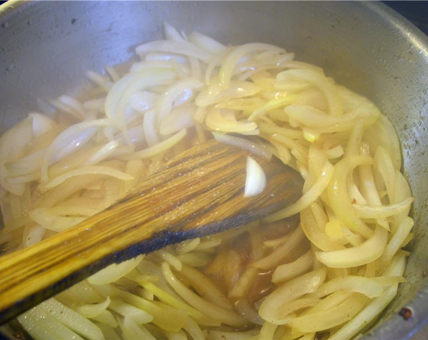 step 5 Add onions to the pan with some Salt (to taste) to help pull out the moisture.  Scrape the bottom of the pan to prevent scorching.