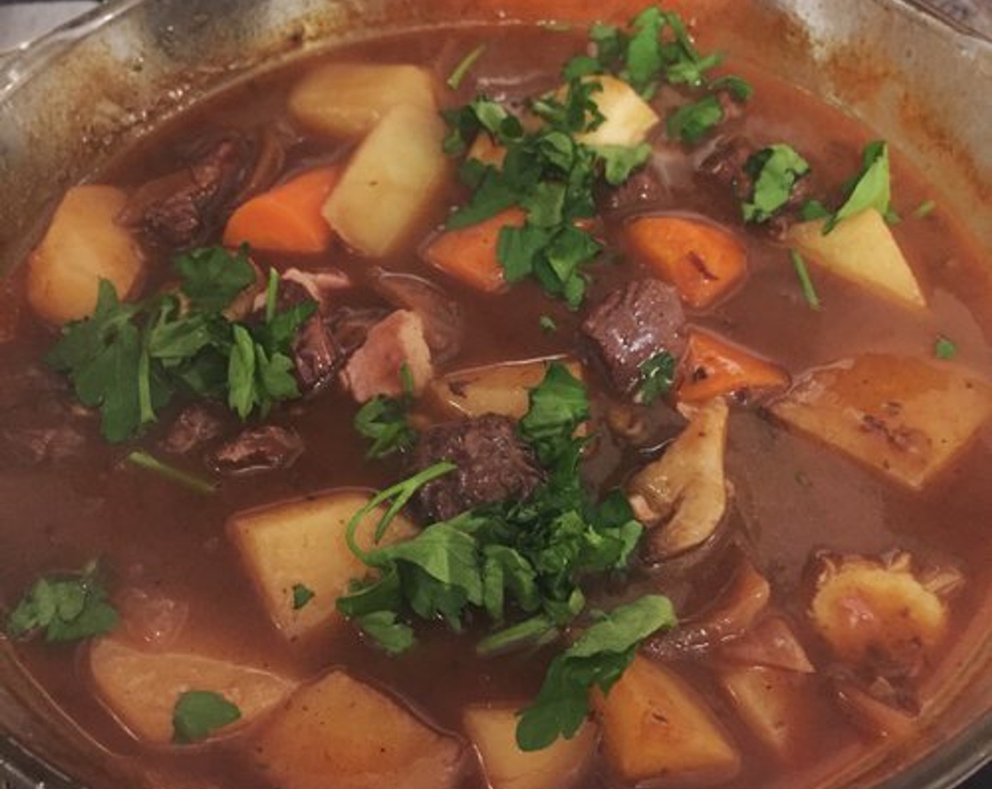 step 9 While this is cooking, saute the Streaky Bacon (3 slices) in a pan, and then the Mushroom (1 handful) in the same pan in the lovely bacon juices. Remove the casserole from the oven and stir in the bacon and mushrooms, and sprinkle with chopped Fresh Parsley (to taste).