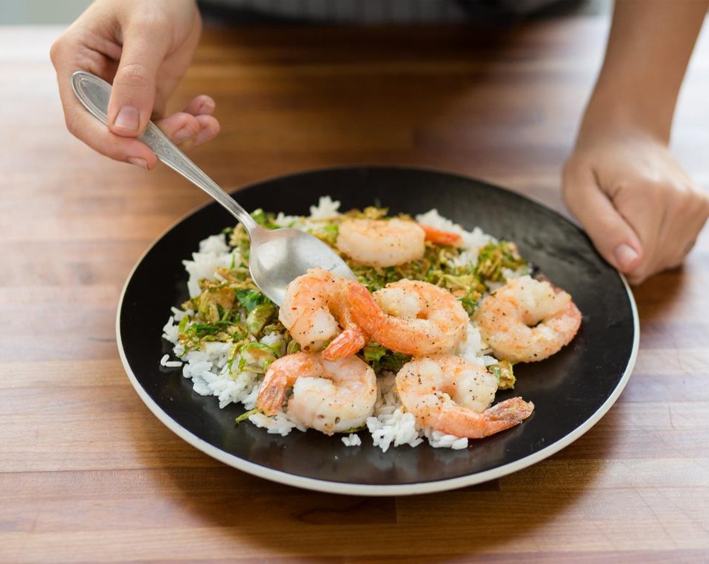 step 8 Divide the rice between two plates. Add the Brussels sprouts and then top with the Peppercorn Shrimp. Serve and enjoy!