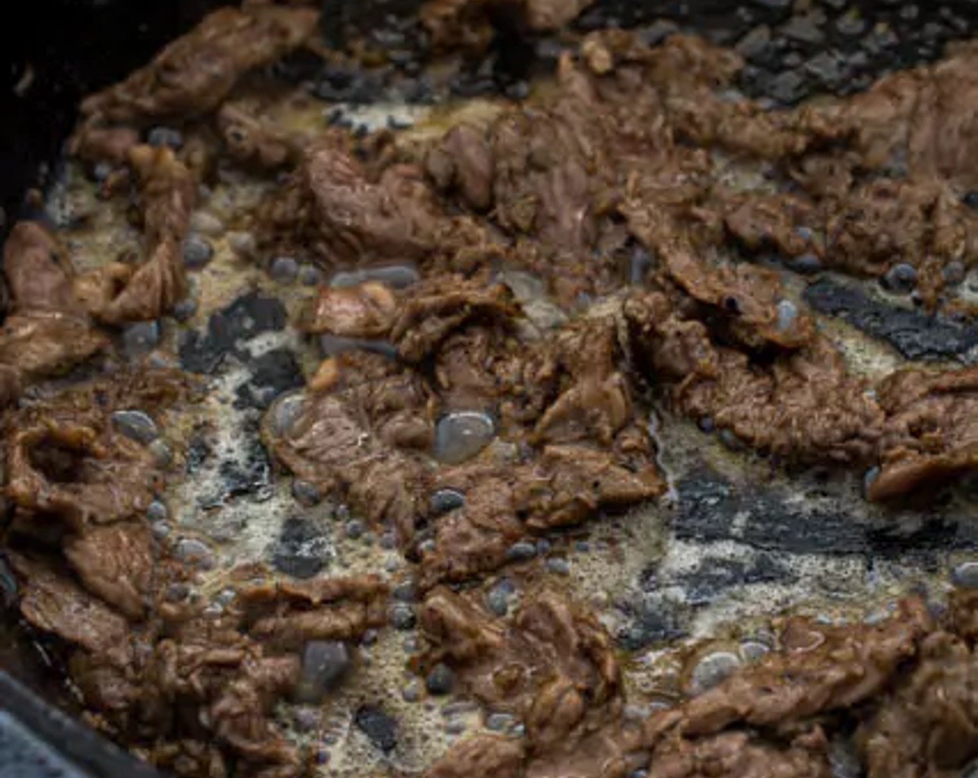 step 5 Add the beef to the skillet in small batches, in single layers at a time. Sear for 1 minute on each side. Add more cooking oil in between each batch if needed.