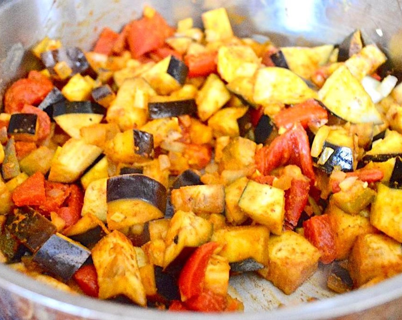 step 2 Heat the Eggplant (1) a deep, oven-proof skillet over medium-high heat, then add the Garlic (4 cloves), Roasted Red Peppers (1 jar), Onion (1), and Olive Oil (1 dash). Let them soften for 5 minutes or so.