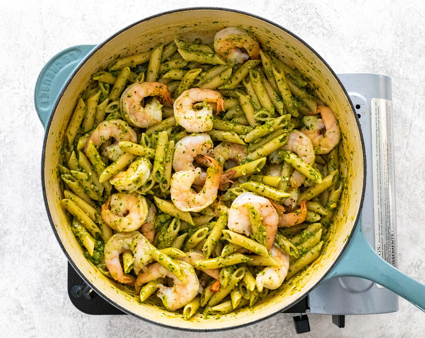 step 6 Add ½ cup of the pesto sauce and gently stir to combine with the pasta. Add more to taste, or save to use for another dish. Add shrimp back to the pan, toss to combine.