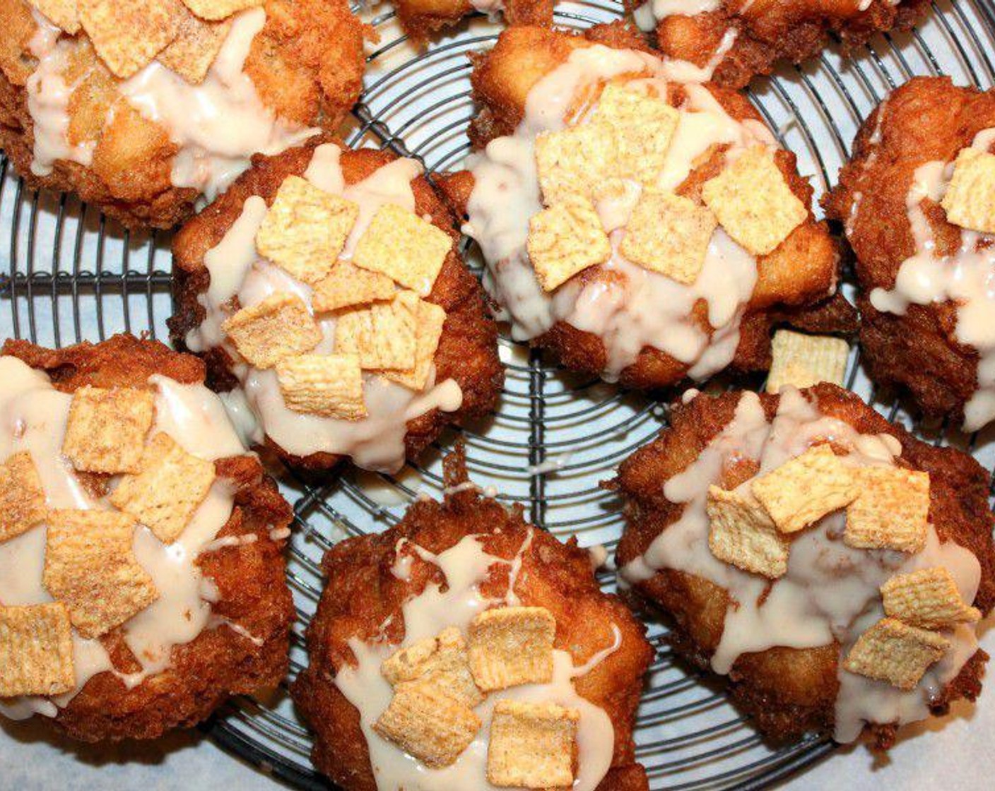 step 6 Drizzle the glaze over the cooled fritters, sprinkle over with some Simply Organic Cinnamon, Ground (to taste) and Caster Sugar (to taste).