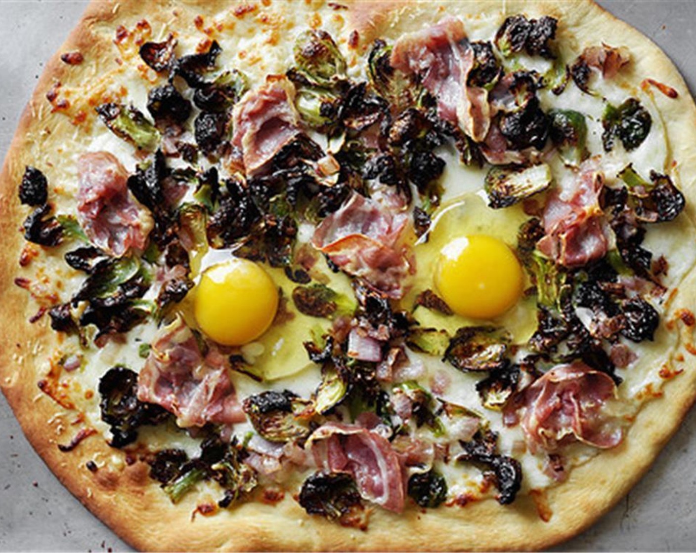 step 14 Remove the pizzas from the oven, and crack the Eggland's Best Classic Eggs (4) onto each pizza. Return to the oven and continue to cook for another 5 minutes for runny yolks.