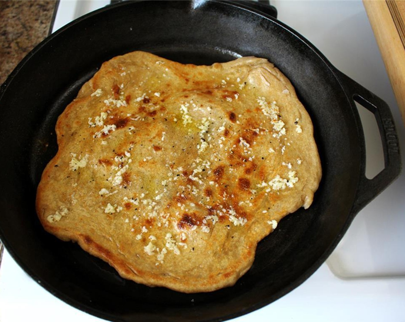 step 1 Add Pizza Dough (1) to a skillet. Cook one side for 2 to 3 minutes, then flip. Top crust with Olive Oil (as needed) and grated or shredded Cheddar Cheese (1/2 cup) and Parmesan Cheese (1/2 cup).