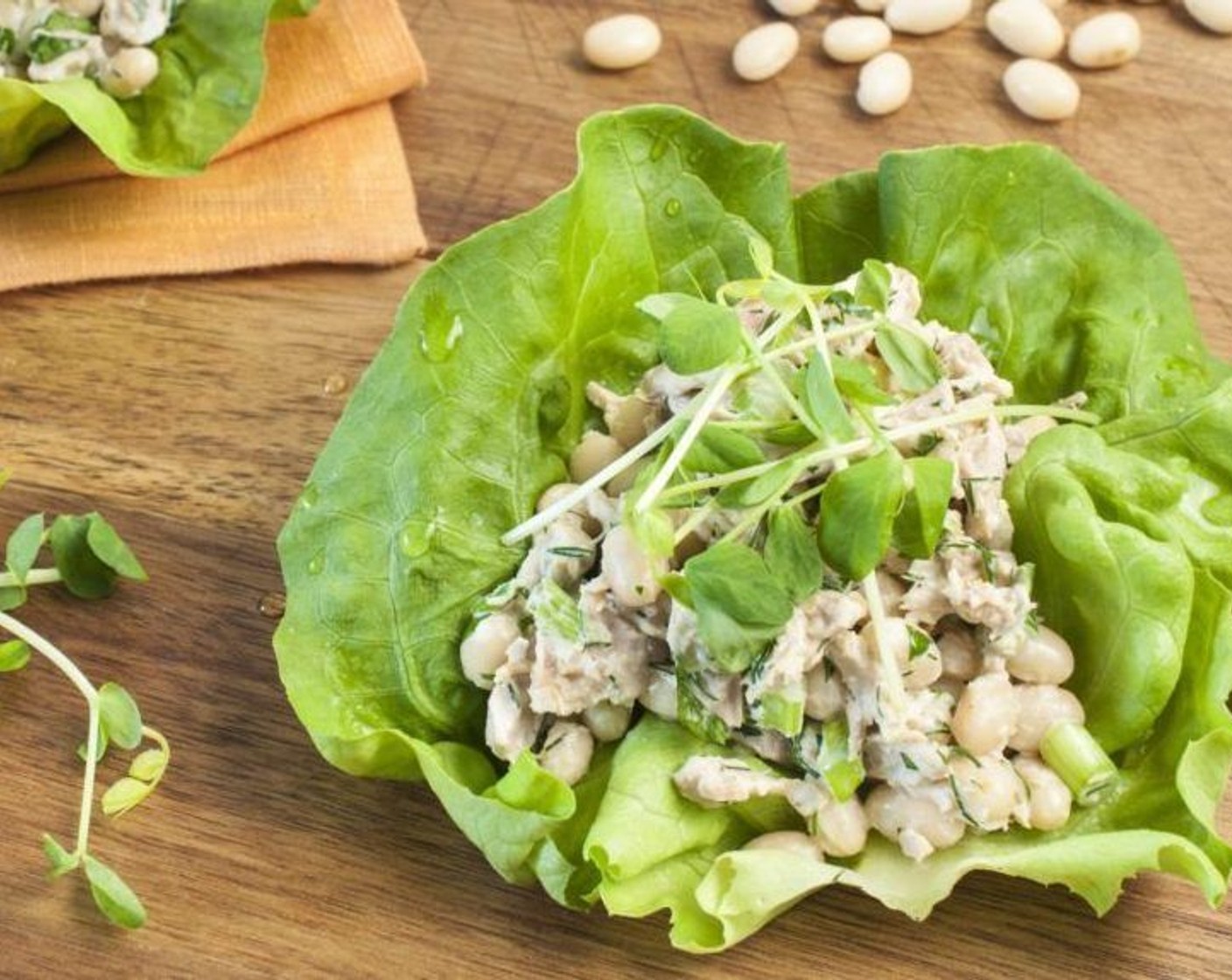 step 4 Mound an approximate 1/3 cup of tuna, Pea Shoots (to taste), and bean salad onto the center of the lettuce bed.