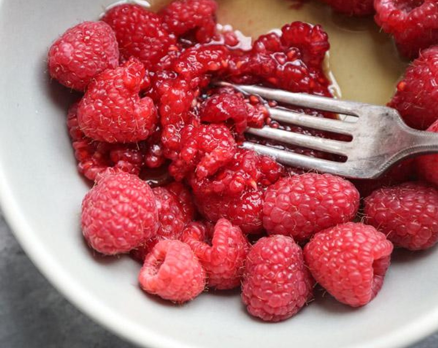 step 2 Meanwhile, in a small bowl, mash the Fresh Raspberries (1 1/3 cups) with the Pure Maple Syrup (1 Tbsp) until it turns into a coarse puree. Divide between 4 glass jars or ramekins.