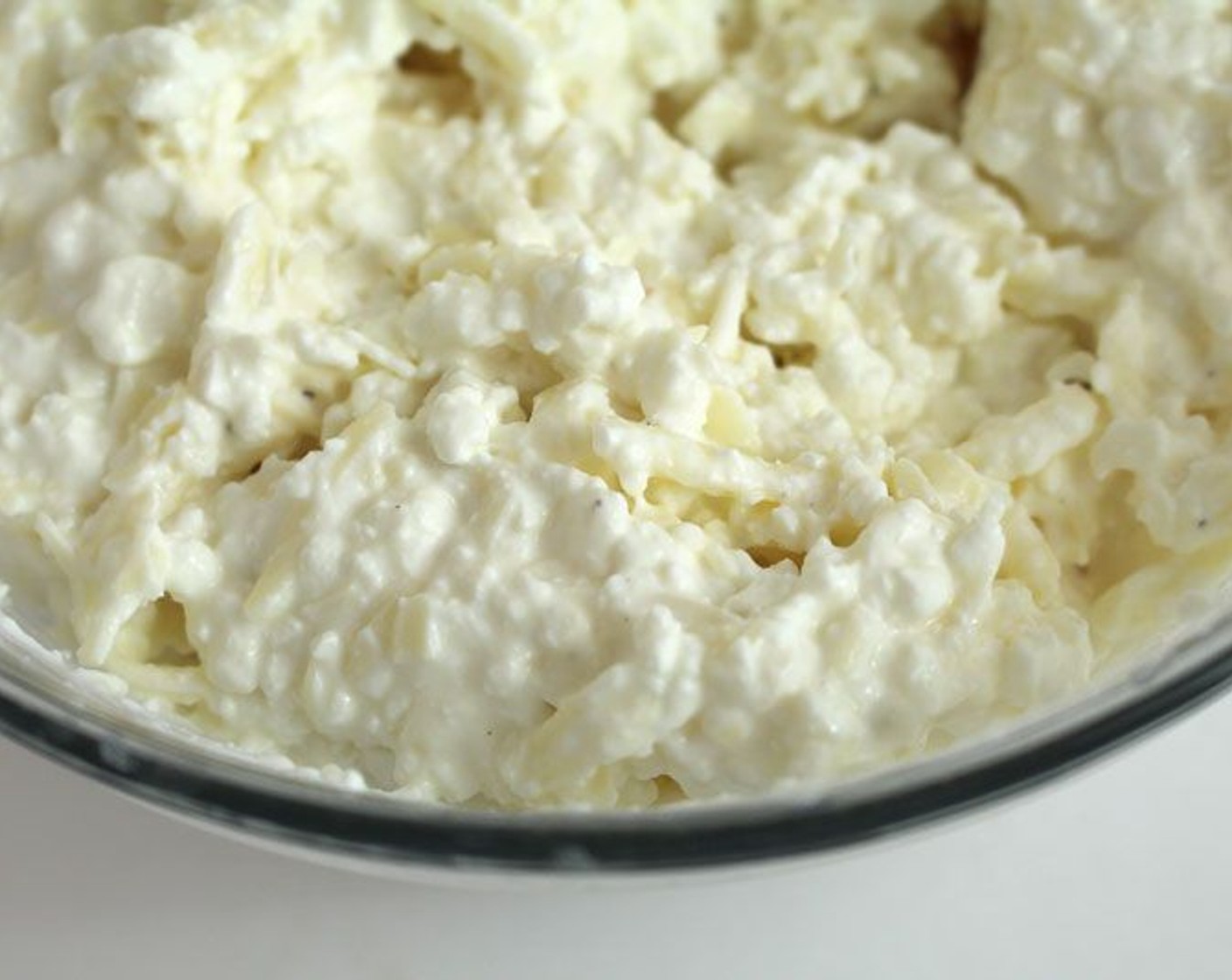 step 4 Mix together Cottage Cheese (2 cups), Greek Yogurt (1/2 cup), Mozzarella Cheese (1 1/2 cups), reserving the rest for later, Parmesan Cheese (1/2 cup), Salt (to taste) and Ground Black Pepper (to taste) for the cheese filling.