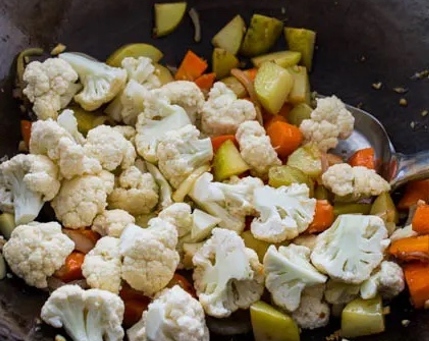 step 3 Add Cauliflower Florets (2 cups) to the wok. Stir for 1 more minute.