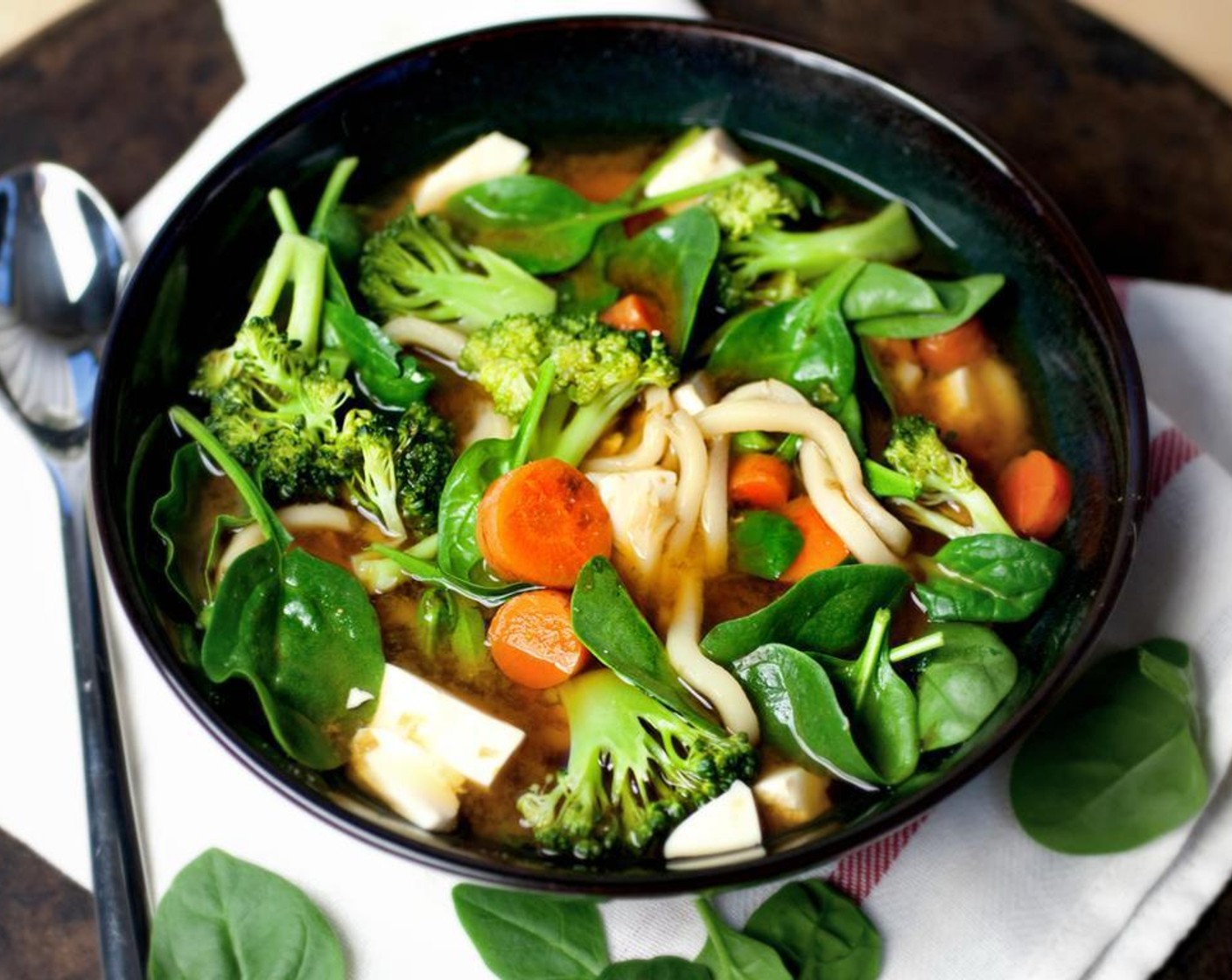 step 6 Serve in a soup bowl and add in the Fresh Spinach (2 handfuls), steamed broccoli, and carrots. Allow a few minutes for spinach to wilt, then eat!