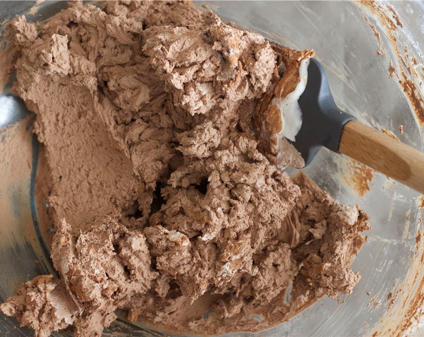 step 4 Pour in the sour cream mixture ¼ cup at a time, beating it in with the mixer.