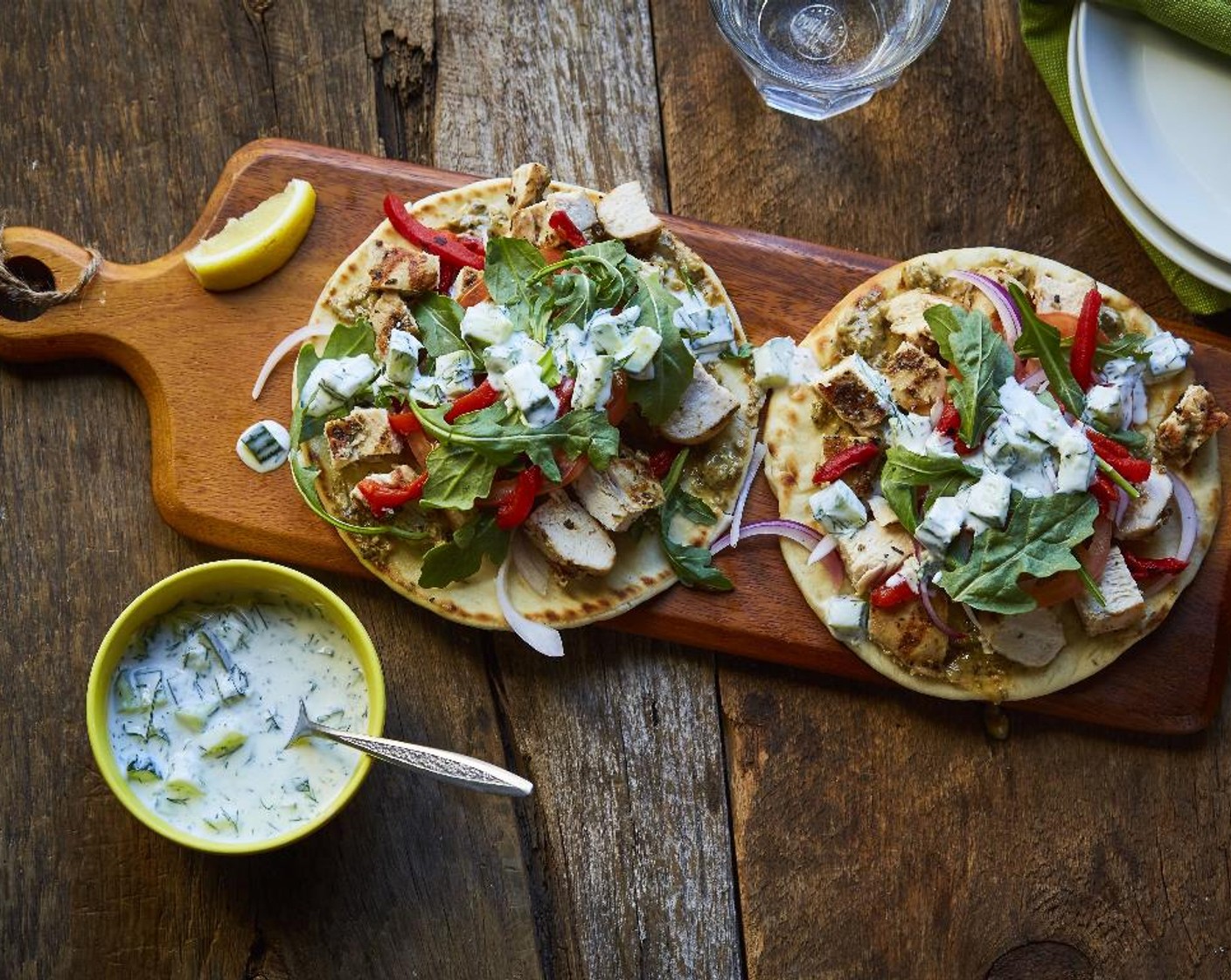 step 16 Spoon the tzatziki over the arugula and garnish with lemon wedges and serve and enjoy!